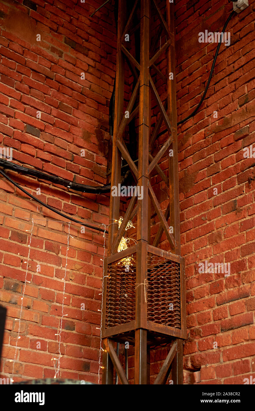 La parete del loft è in mattoni rossi Con raccordi in metallo. Lo stile industriale Foto Stock