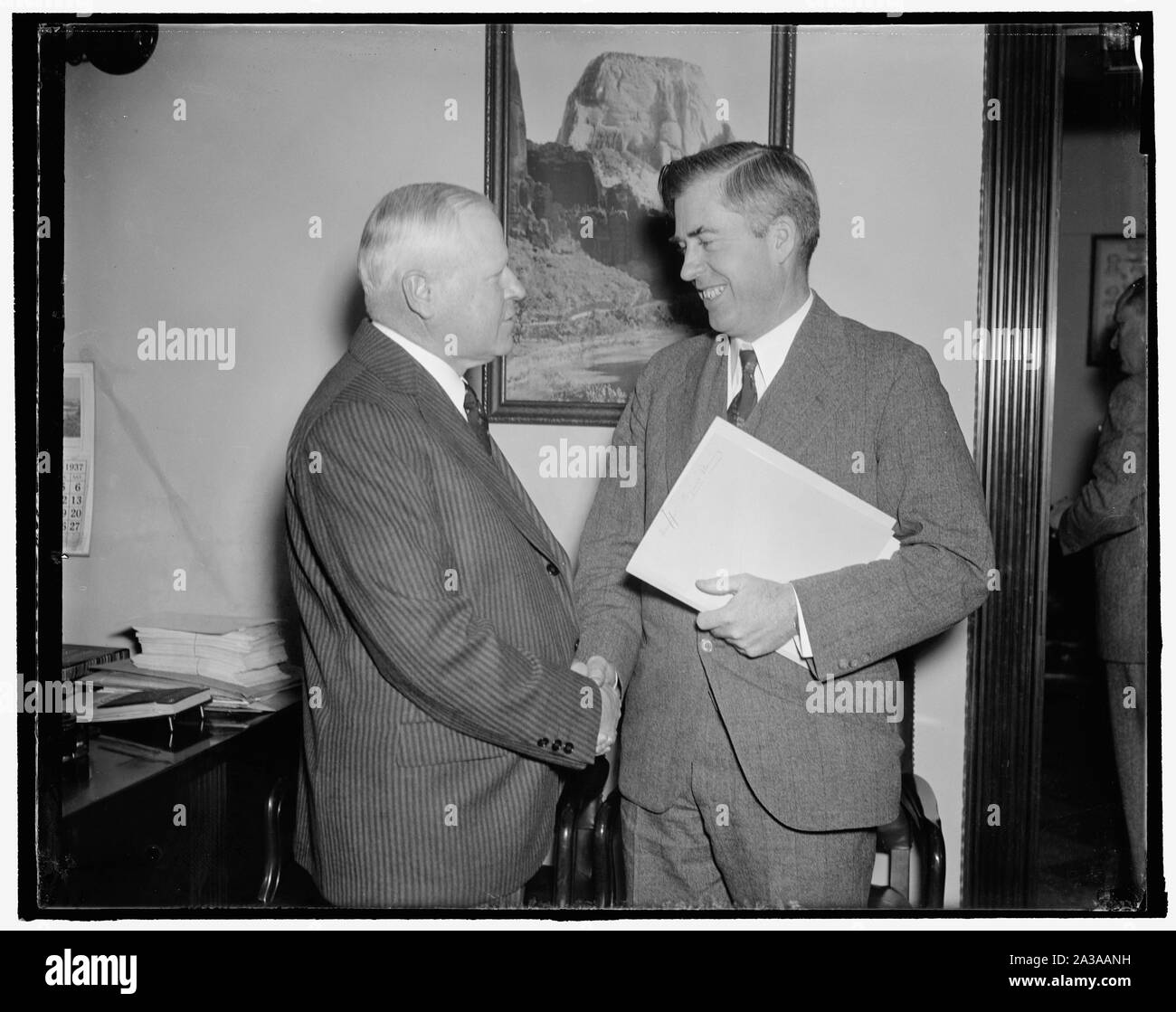 Segretario di Agricoltura e governatore del Wyoming prima casa fiumi e porti comm. Washington D.C., nov. 30. Segretario di Agricoltura Henry A. Wallace, (destra) e Governatore Leslie Miller, del Wyoming, soddisfare appena prima della loro apparso davanti la casa di fiumi e porti comitato. Wallace ha proposto al comitato che la pianificazione regionale bill essere modificato per rendere le autorità di pianificazione più advisory. Gov. Miller a carico che il disegno di legge nella sua forma attuale sarebbe eliminare le linee di stato e distruggere la sovranità dello stato. 11/30/37 Foto Stock