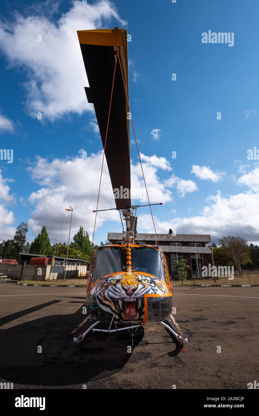 Vryheid, Sud Africa, 1 ottobre 2019. Un Bell Huey elicottero con una tigre personalizzati motif paint job è pronta per azione durante la stagione di estinzione in Vryheid, Sud Africa. Bell Huey elicotteri sono un iconico modello sviluppato per i militari USA e ampiamente utilizzato durante e dopo la guerra del Vietnam. Foto Stock