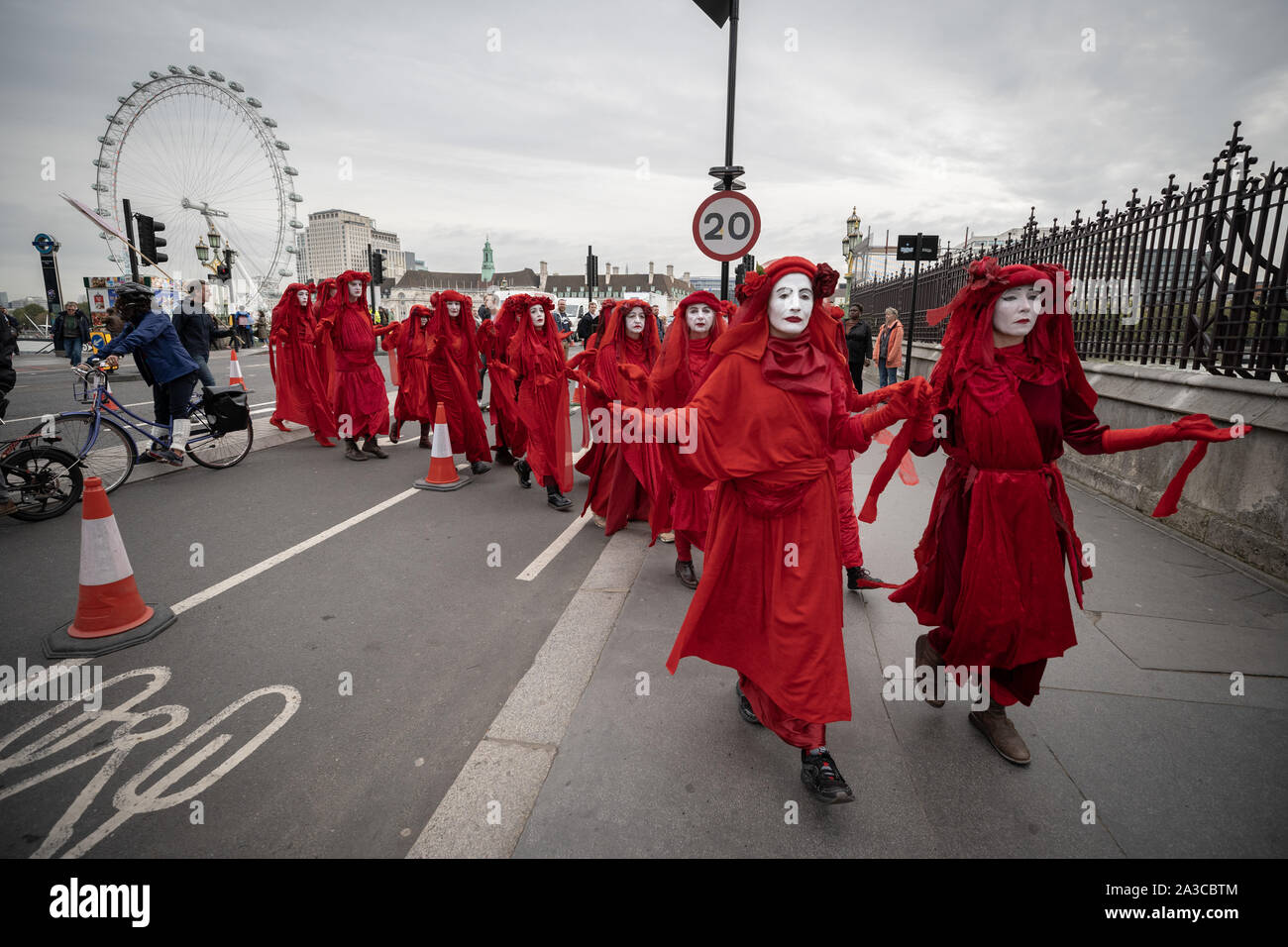 Londra, Regno Unito. Il 7 ottobre, 2019. Estinzione Rebellion 'Rosso brigata di ribelli' arrivano a Westminster nel loro marchio rosso sangue outfits per unirsi alla protesta. Il attivisti ambientali iniziare una nuova ondata di azione di protesta questa mattina causando interruzioni presso i siti principali di Londra. Credito: Guy Corbishley/Alamy Live News Foto Stock
