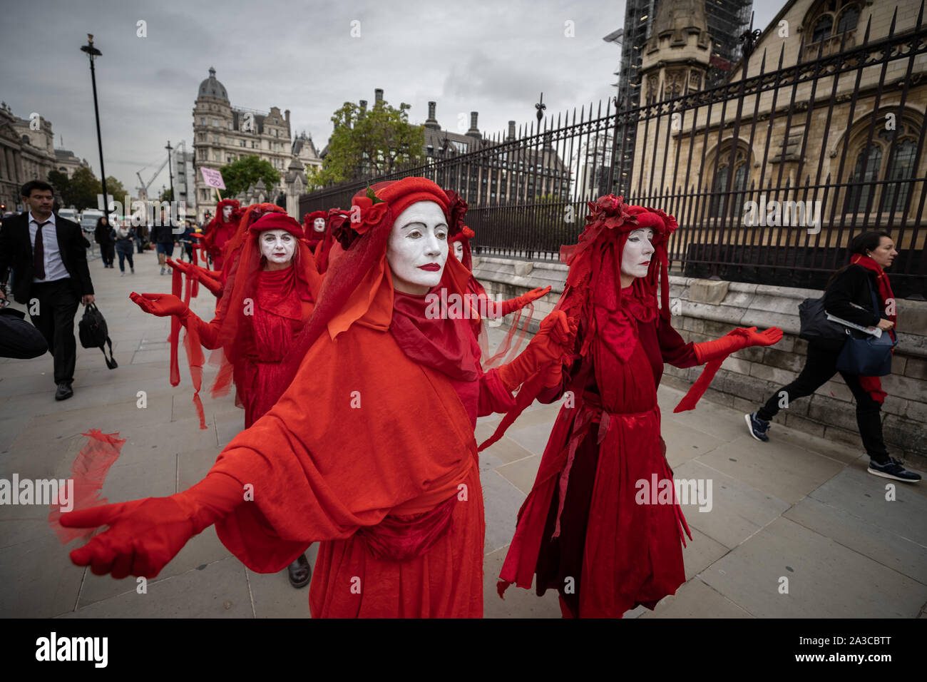 Londra, Regno Unito. Il 7 ottobre, 2019. Estinzione Rebellion 'Rosso brigata di ribelli' arrivano a Westminster nel loro marchio rosso sangue outfits per unirsi alla protesta. Il attivisti ambientali iniziare una nuova ondata di azione di protesta questa mattina causando interruzioni presso i siti principali di Londra. Credito: Guy Corbishley/Alamy Live News Foto Stock