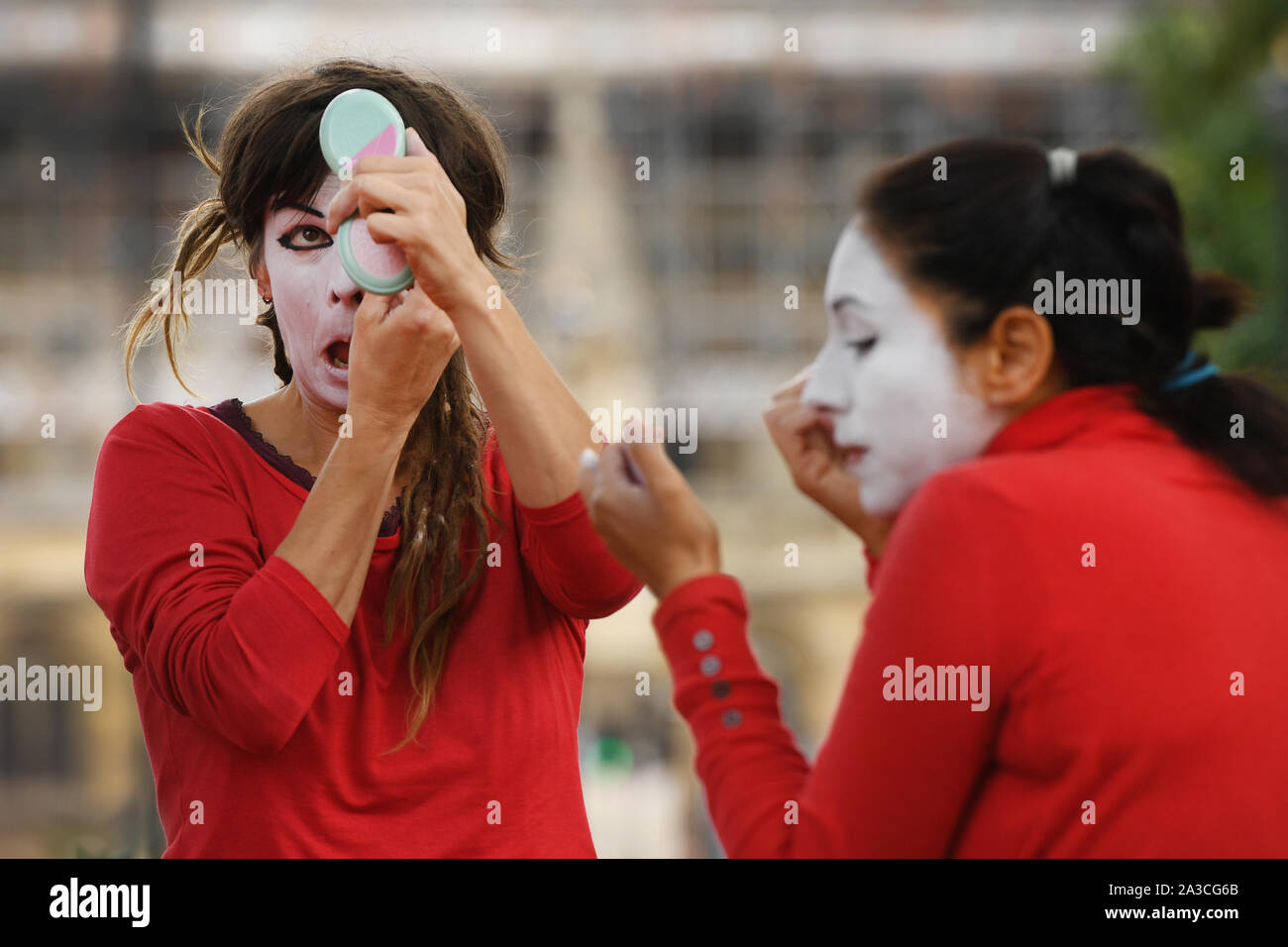 Membri del 'Rosso Brigata" entrare in costume e applicare il make-up per un'estinzione della ribellione protesta in Westminster, Londra. Foto Stock