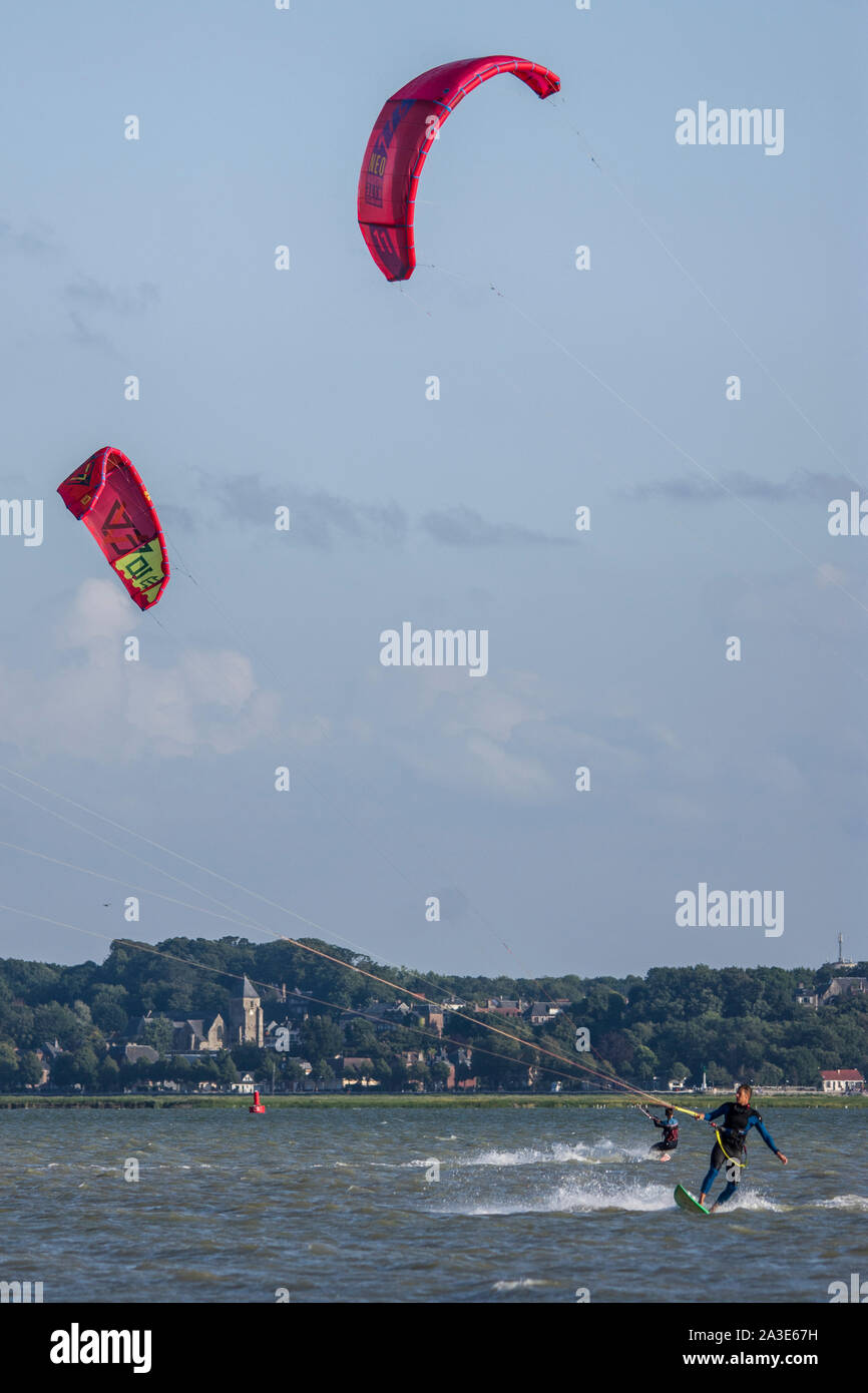 Kitesurf dans la baie de Smme, face au Crotoy et à Saint Valery sur Somme par jour venteux et ensoleillé. Voiles de couleur, vitesse sur l'eau Foto Stock