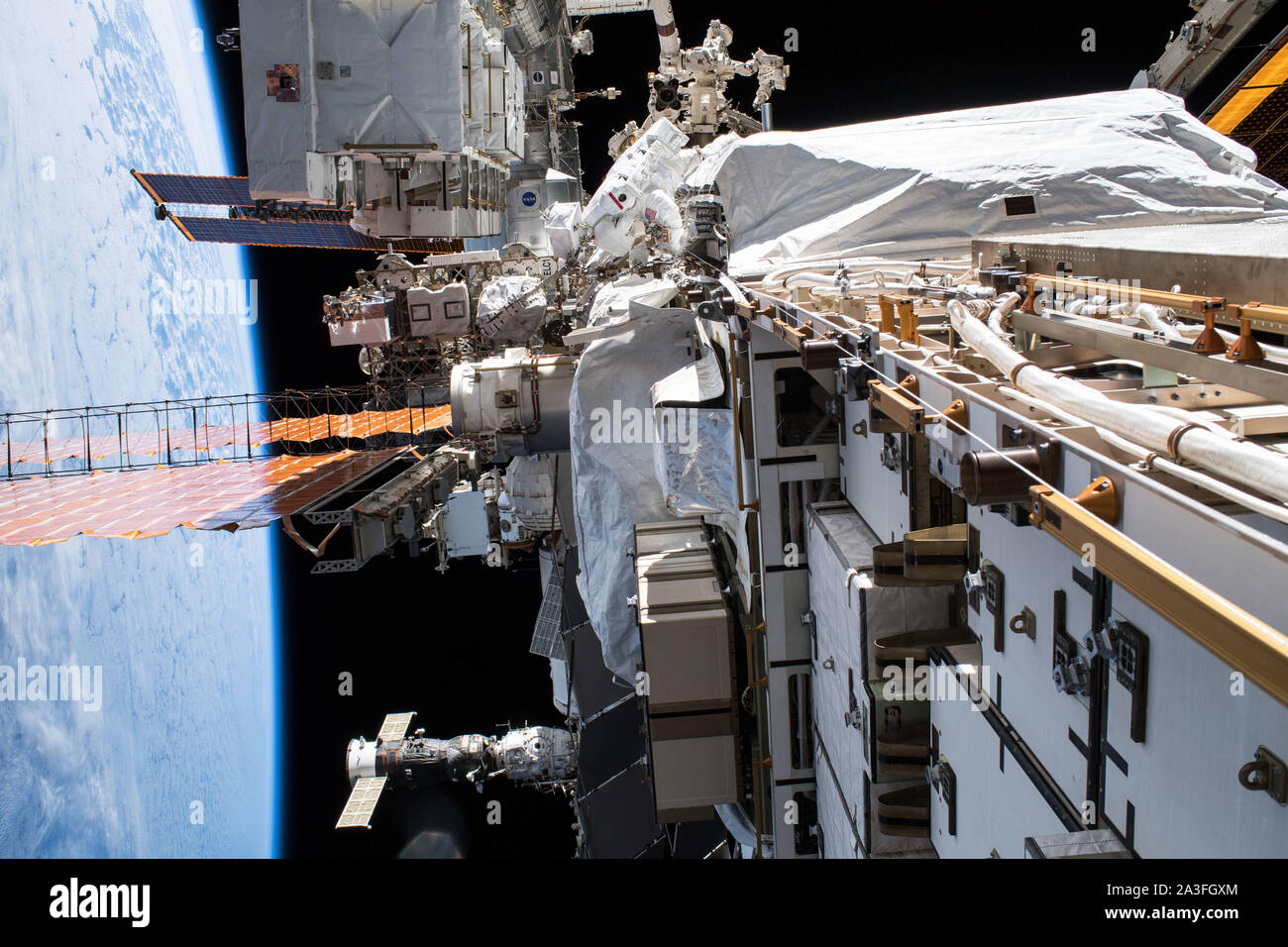 L'astronauta della NASA Christina Koch, centro superiore, nel corso di una spacewalk per aggiornare la Stazione spaziale internazionale i sistemi di potenza 6 ottobre 2019 in orbita intorno alla terra. Koch e compagno astronauta della NASA Andrew Morgan, trascorso sette ore di aggiornamento del laboratorio orbitante grande nichel-idrogeno batterie con più nuove e potenti batterie agli ioni di litio. Foto Stock