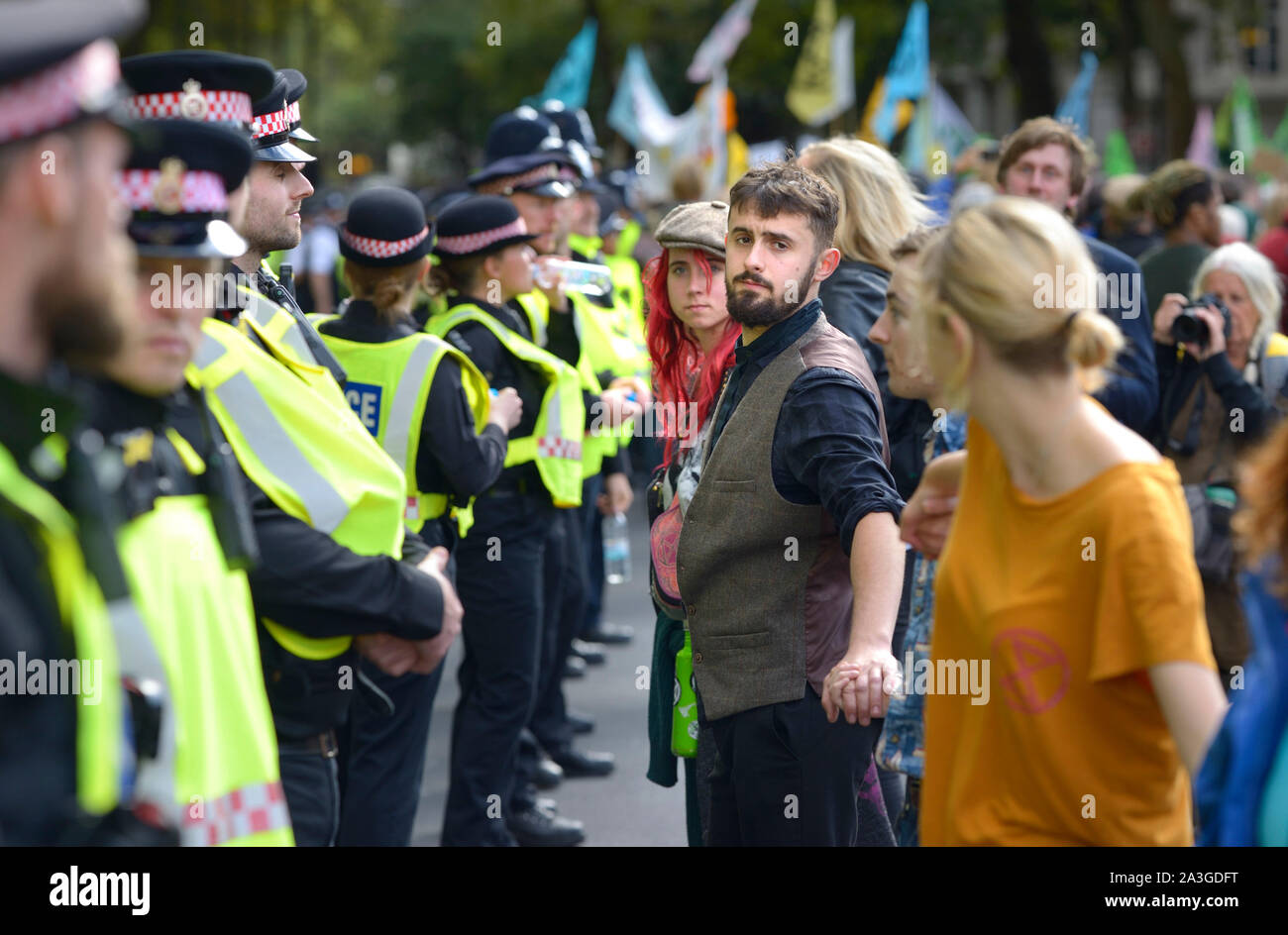 Londra, Regno Unito. 8 ottobre 2019. Estinzione della ribellione proteste portare il centro di Londra da una battuta di arresto per una seconda giornata. I dimostranti danzano davanti delle forze di polizia al di fuori del Parlamento Credito: PjrFoto/Alamy Live News Foto Stock