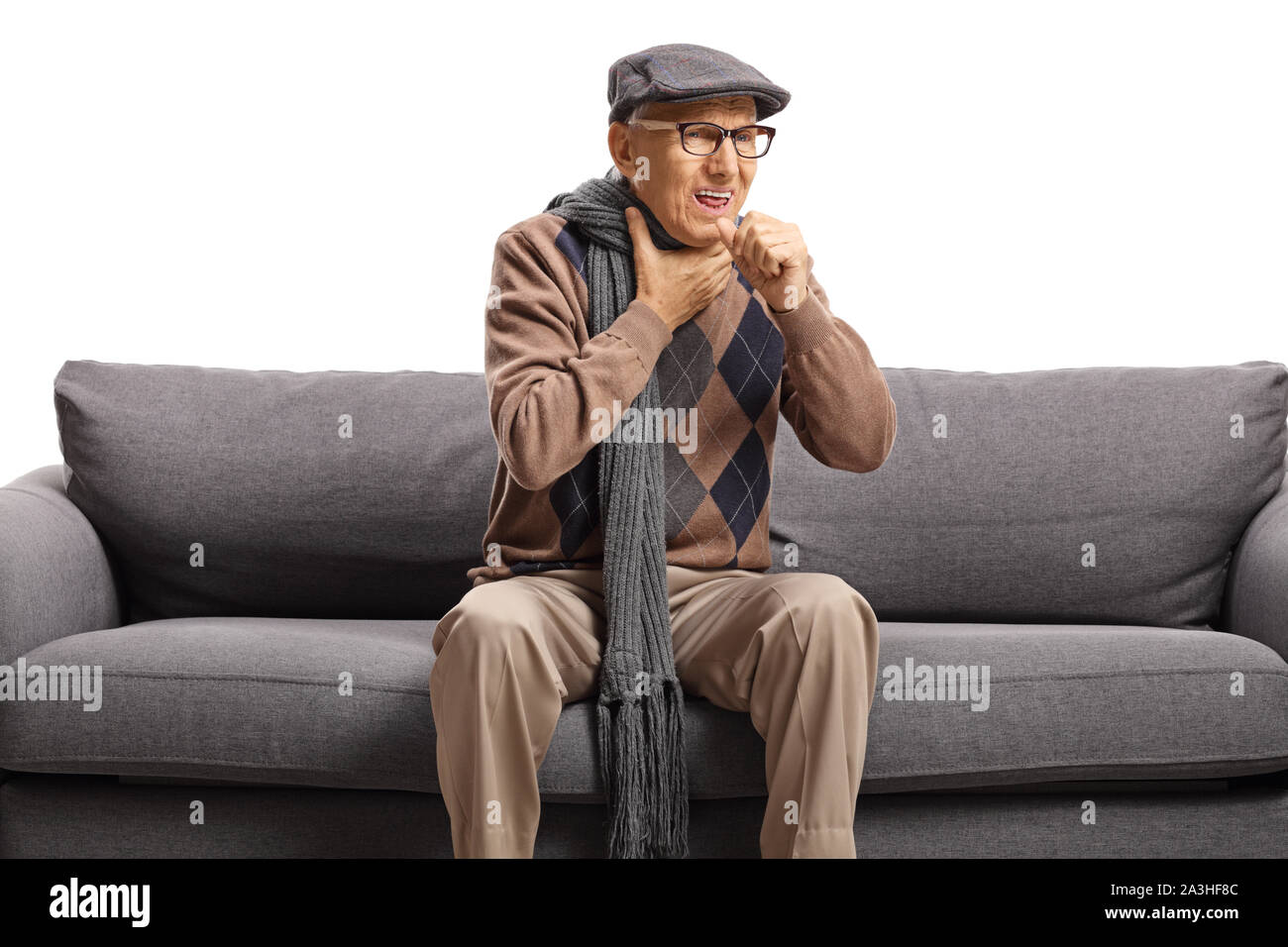 Anziani uomo seduto su un divano e tosse isolati su sfondo bianco Foto Stock