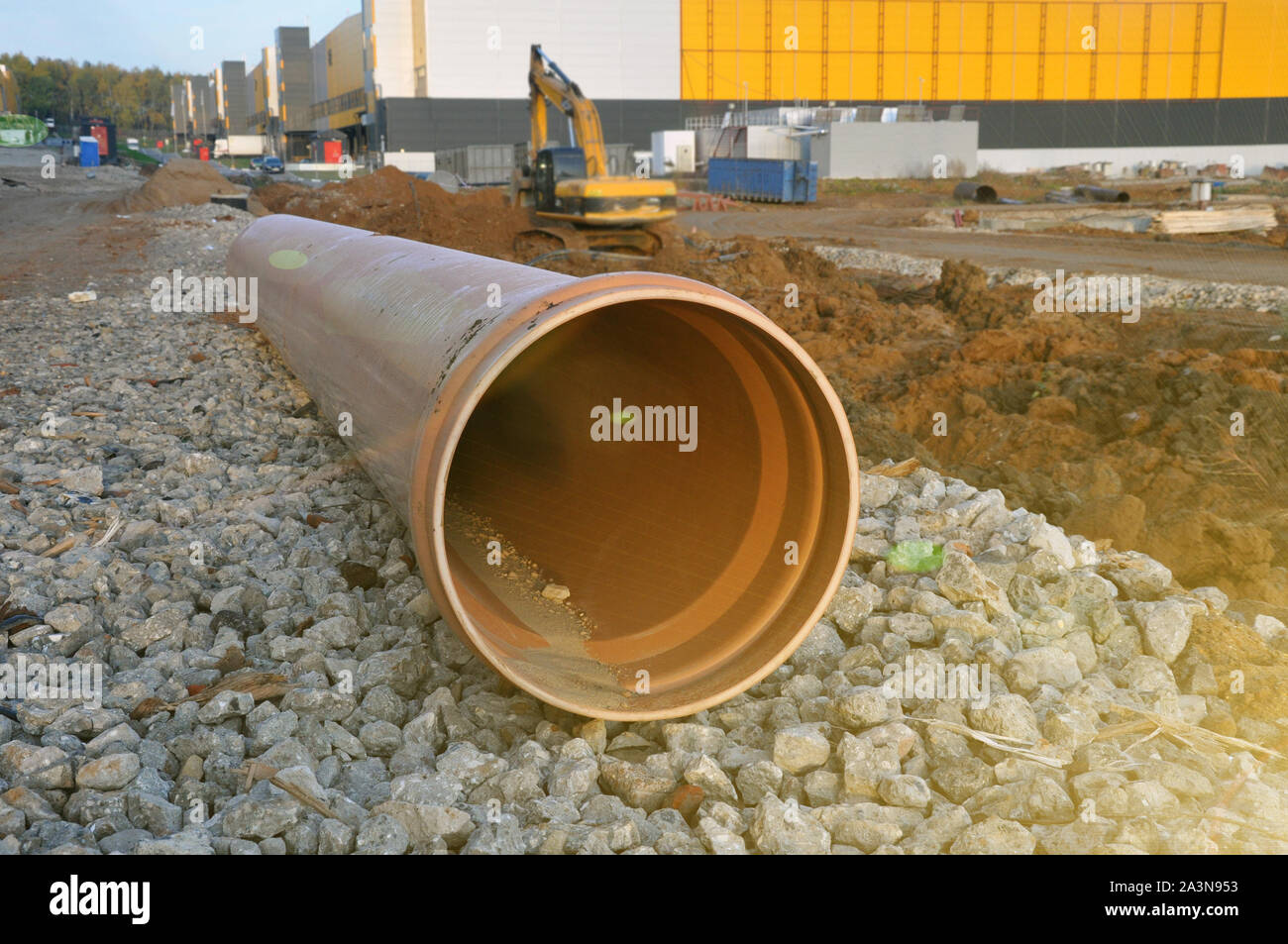 Un tubo di plastica giacente sul territorio del sito di costruzione per le necessità di smaltimento dell'acqua. Foto Stock