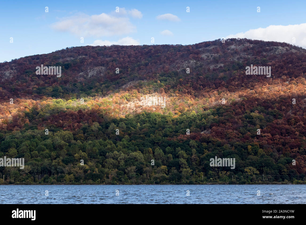 La luce del sole e ombre sulla Hudson Highlands dal fiume Hudson in un pomeriggio autunnale il 4 ottobre, 2019. Foto Stock
