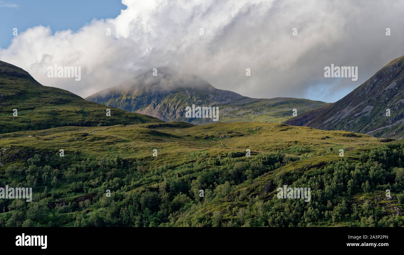 Stob Coire na h-Eirghe (826M) nelle nuvole, con pendenze di Beinn na Caillich (sinistra) & Sgurr un Fhuarain (destra) visto dal lato del sud di Loch Leven Foto Stock