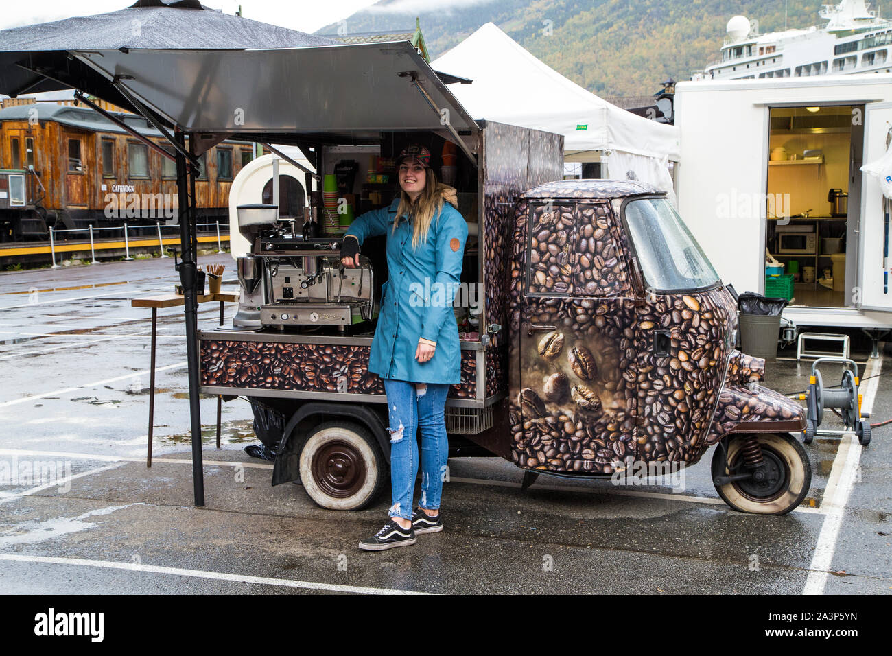 Una giovane donna si erge accanto al suo cellulare Carrello Caffè in Flam Norvegia. Foto Stock