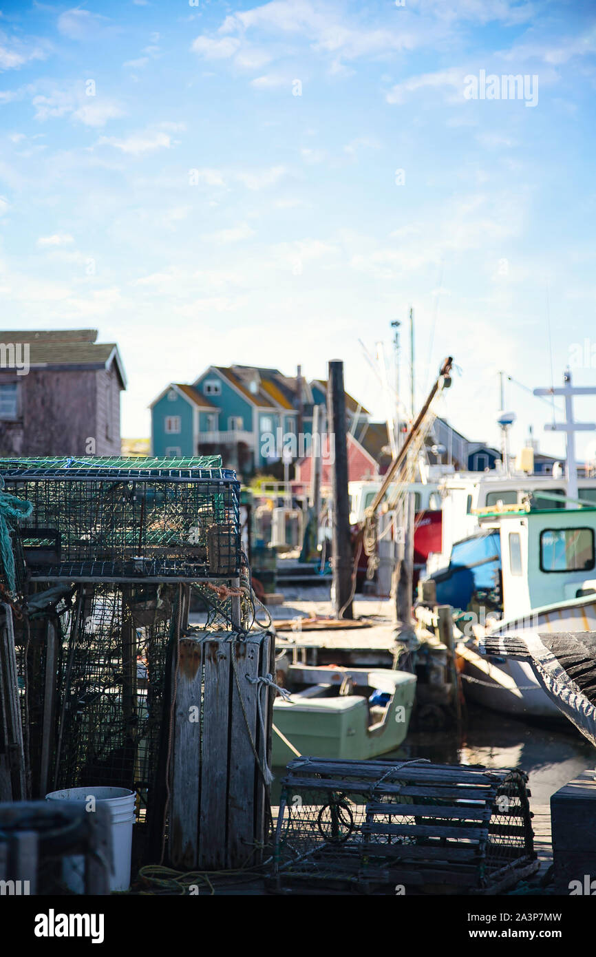Barche da pesca e gabbie di granchio colorate fiancheggiano le banchine nella storica Peggy's Cove, Nuova Scozia, Canada Foto Stock