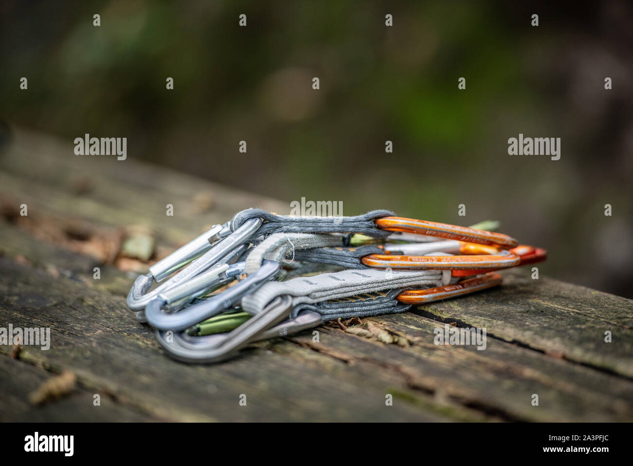 Arrampicata moschettoni in appoggio su un tavolo di legno Foto Stock