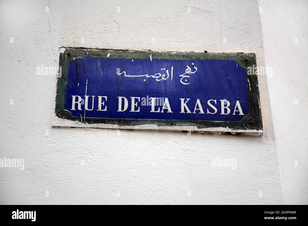 Un cartello stradale in Francese e Arabo sulla Rue De La Kasba trovati nella Kasbah quartiere della Medina (città vecchia) di Tunisi, Tunisia. Foto Stock
