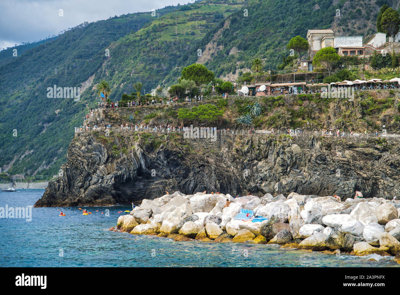 Cinque Terre, Italia - Agosto 17, 2019: viaggio in barca lungo la costa ligure. Paesaggio di montagna con edifici residenziali. Sentiero Natura in italiano Foto Stock