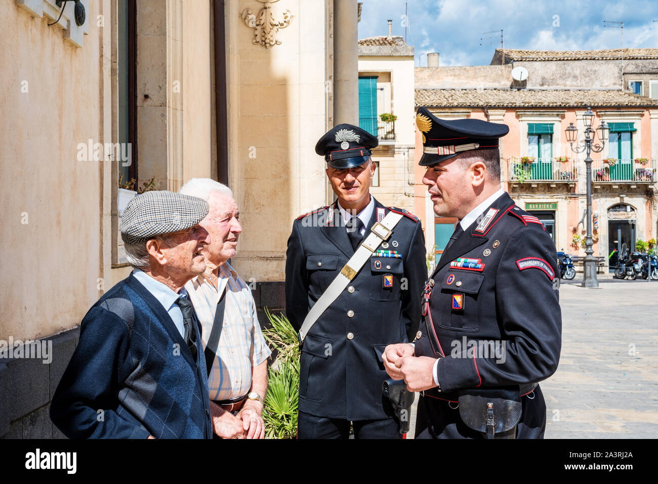 Siracusa Sicilia/ Italia - ottobre 04 2019: Carabinieri discutere con due persone anziane nella piazza del paese Foto Stock