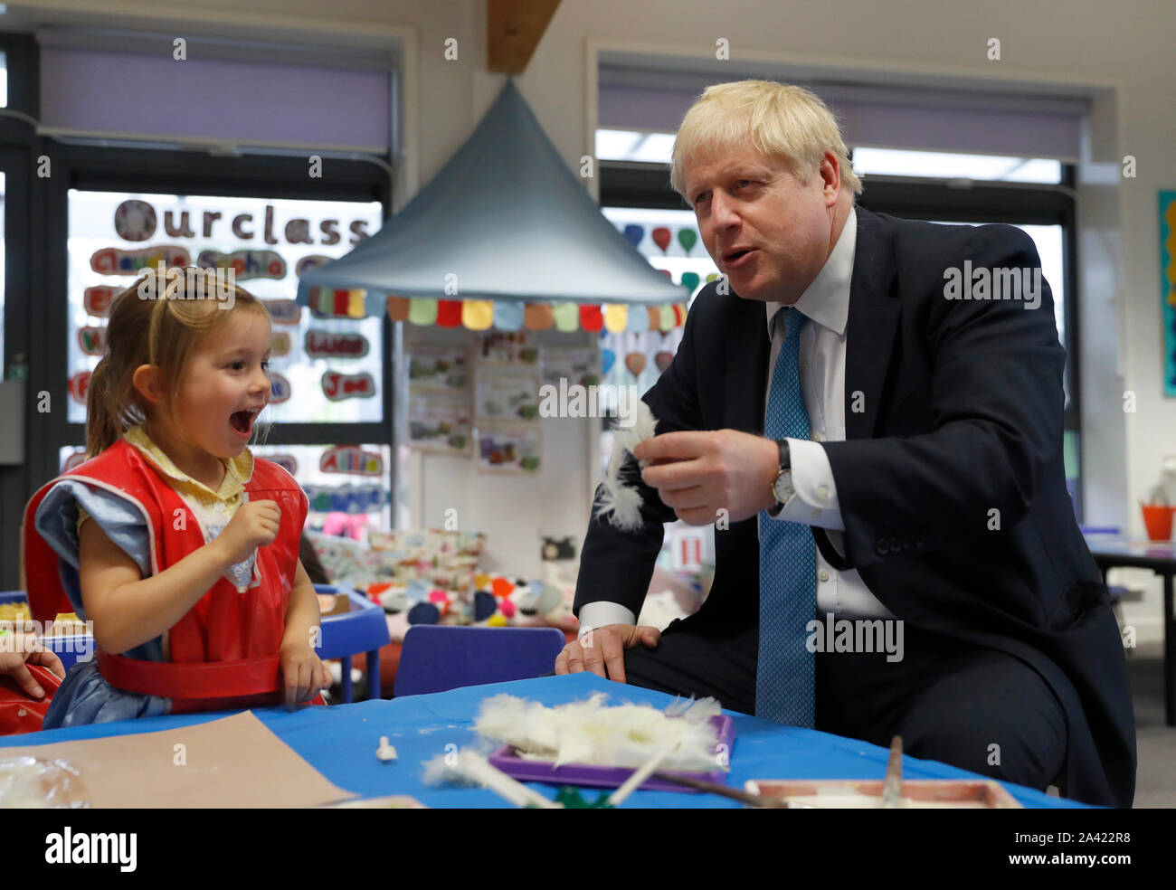 Il primo ministro Boris Johnson gesti come egli partecipa a un arte di classe con quattro anni di Scarlet Fickling durante una visita a St Mary e tutti i santi la scuola primaria a Beaconsfield, Buckinghamshire per un annuncio su assegnazioni di fondi per le scuole in tutta l'Inghilterra. Foto Stock