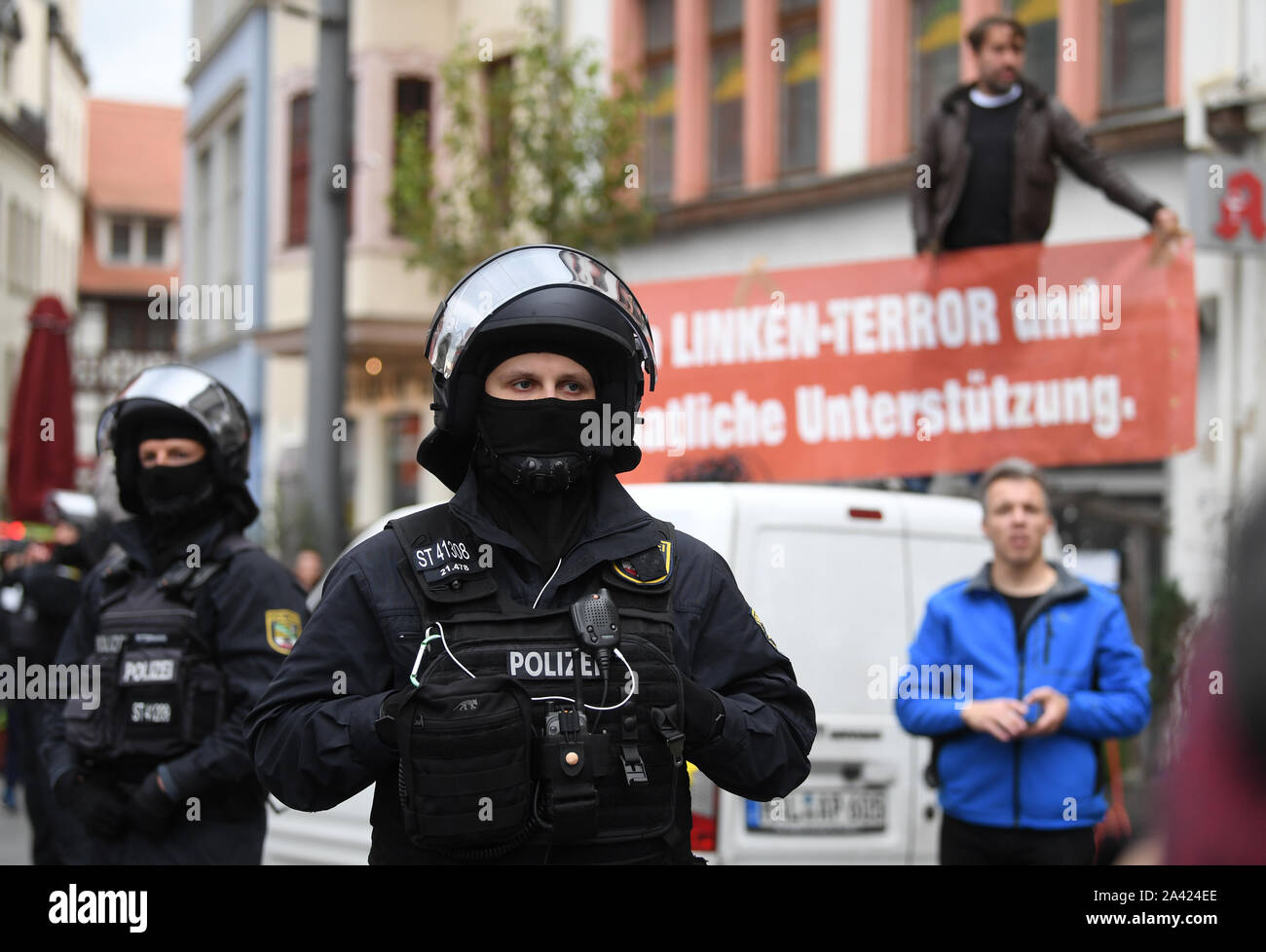 Halle, Germania. 11 ott 2019. I poliziotti sono in piedi sulla piazza del mercato di fronte alla estrema altoparlante destro Sven Liebich (destro sul bus). Su 09.10.2019, due persone sono state uccise durante un attacco da parte di un estrema destra colpevole di fronte ad una sinagoga di Halle. Credito: dpa picture alliance/Alamy Live News Foto Stock