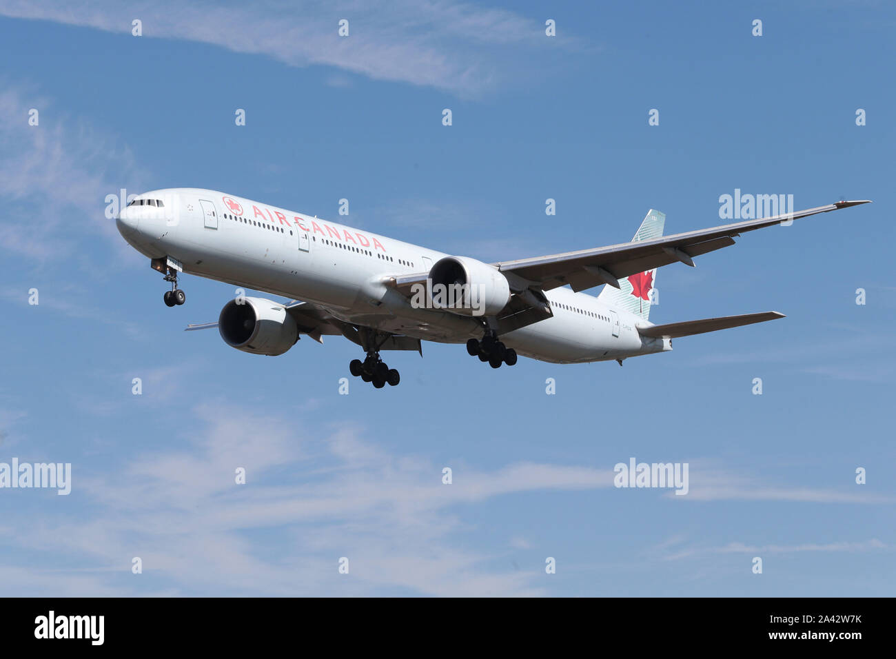 In uscita del cielo blu con sotto il carrello che scende a terra all'Aeroporto Heathrow di Londra nel Regno Unito Foto Stock