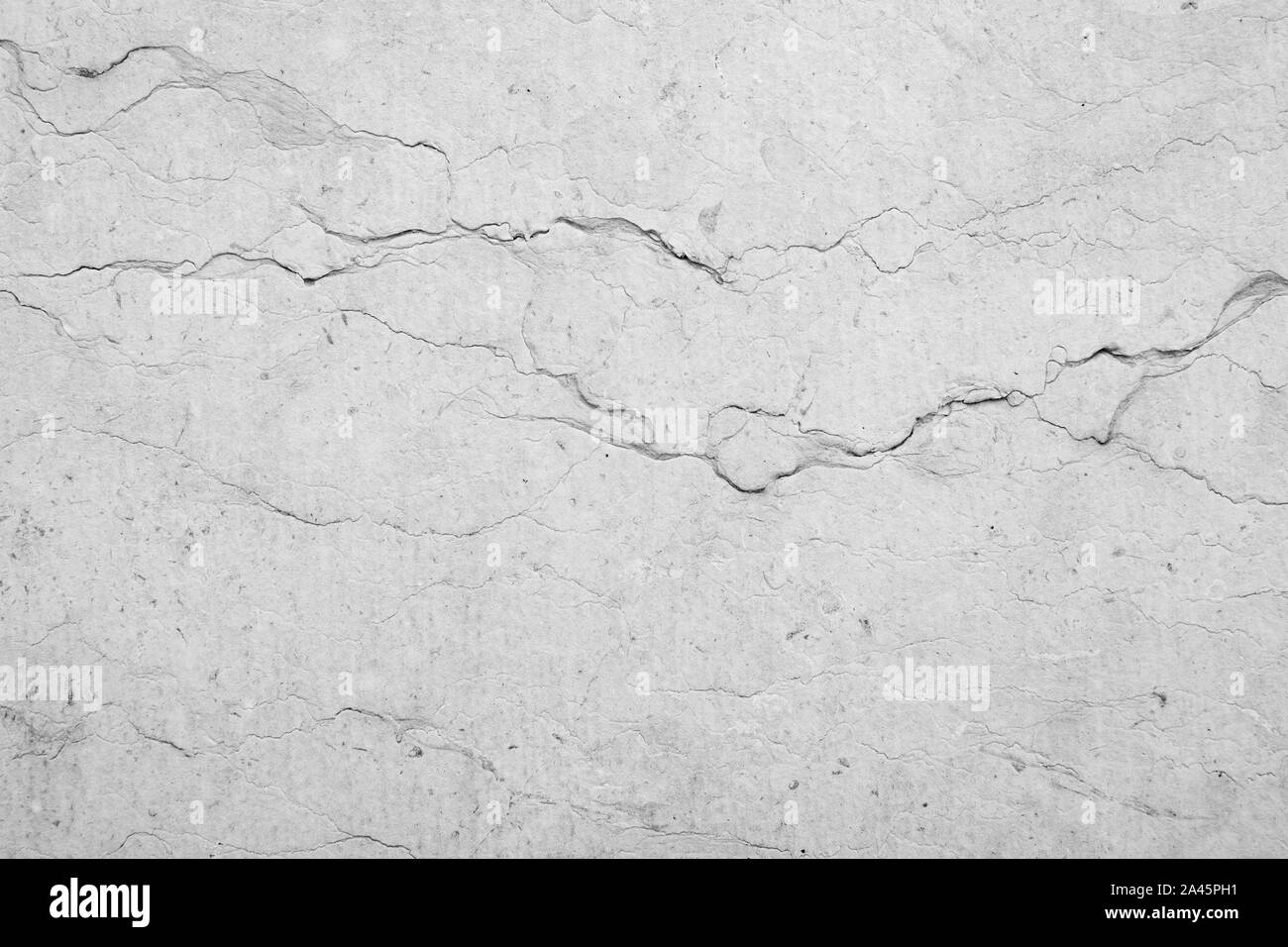 Close-up di un vecchio, weathered e screpolata muro di pietra con le vene. Alta risoluzione full frame sfondo strutturata in bianco e nero. Foto Stock