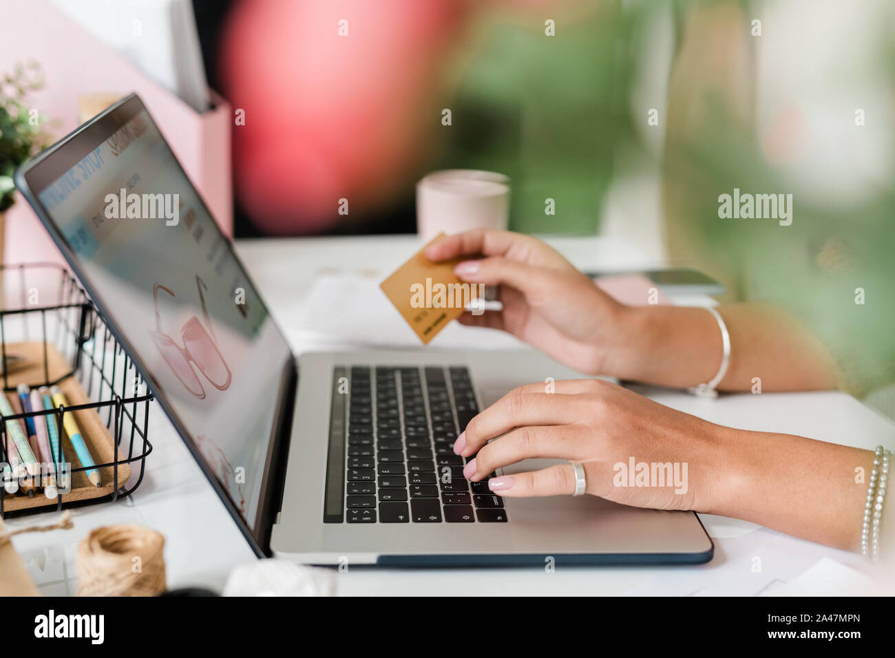 Le mani della giovane donna sulla tastiera del notebook occhiali di ordinazione in internet Foto Stock