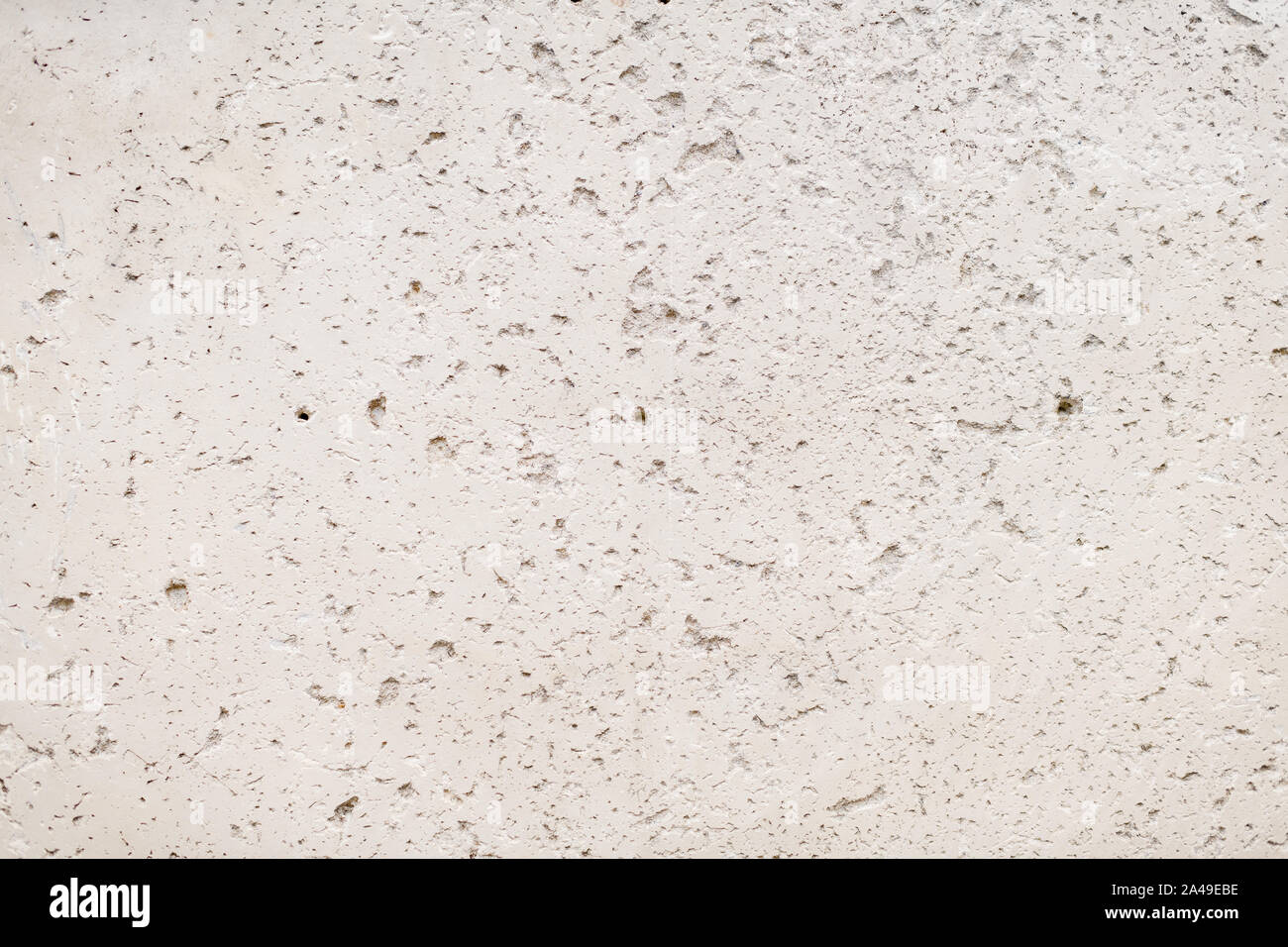 Materiale ruvido muro di cemento con superficie naturale di incrinature e fori Foto Stock