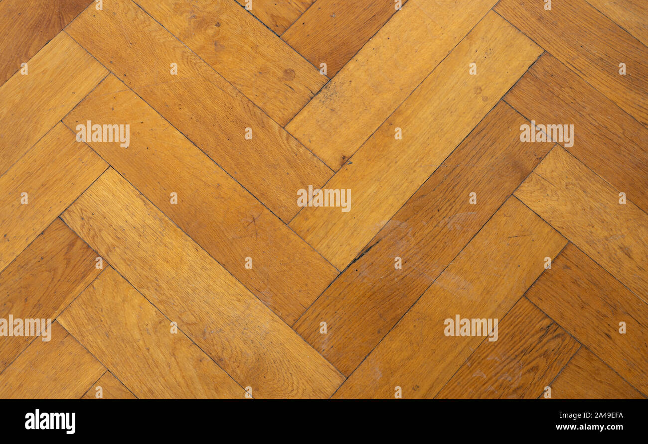Pavimento in legno di sfondo - parquet a spina di pesce sfondo Foto Stock