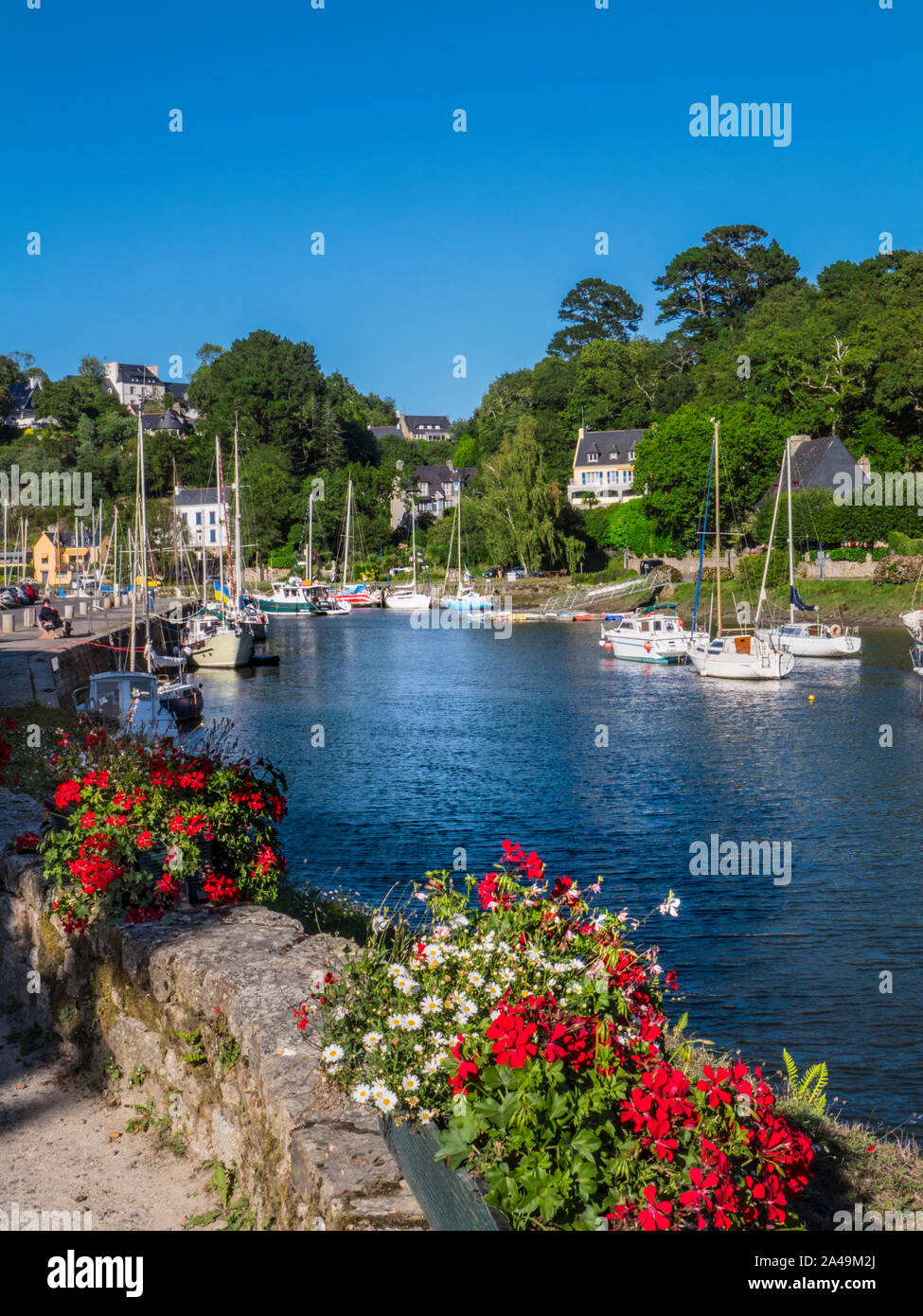 Pont-Aven Brittany floral sunny scena di paesaggio con barche a vela e le case sulle rive del fiume Aven dipartimento di Finistère Bretagna Francia Foto Stock