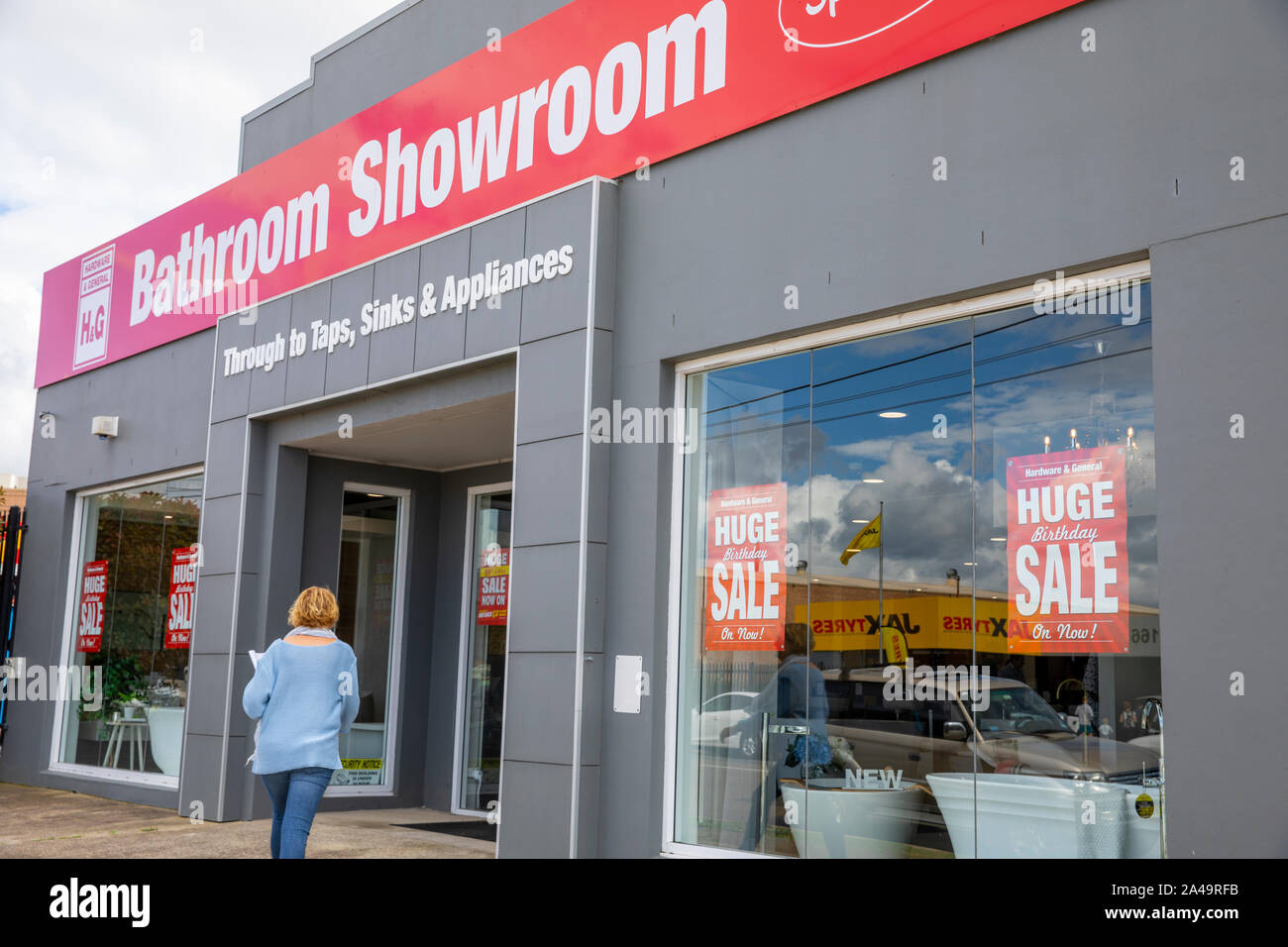 Bagno showroom con la donna in ingresso nel magazzino di Sydney , Australia vendita di vasche da bagno, lavandini e toelette Foto Stock