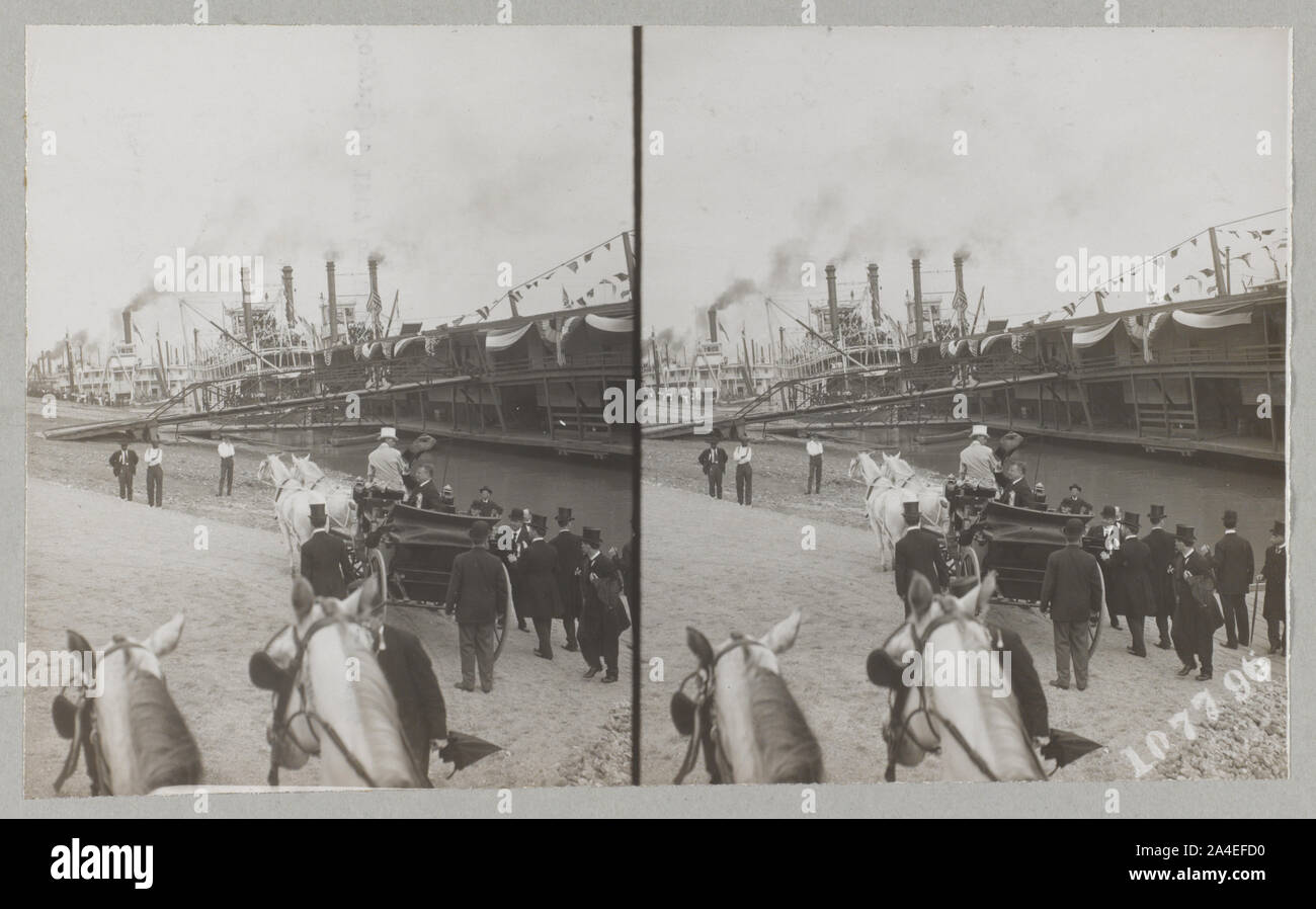 Theodore Roosevelt seduto in carrozza trainata da cavalli sventolano al pubblico con il suo cappello. Numerosi piroscafi sono ancorati lungo la banca Foto Stock