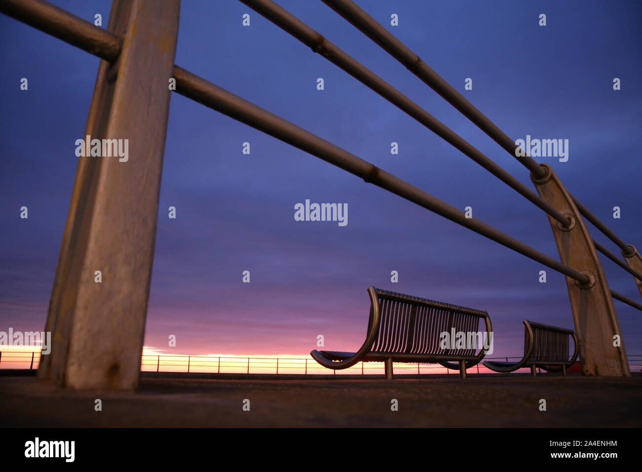 Banchi vuoti sul lungomare di Blackpool, Regno Unito, al tramonto. Foto Stock