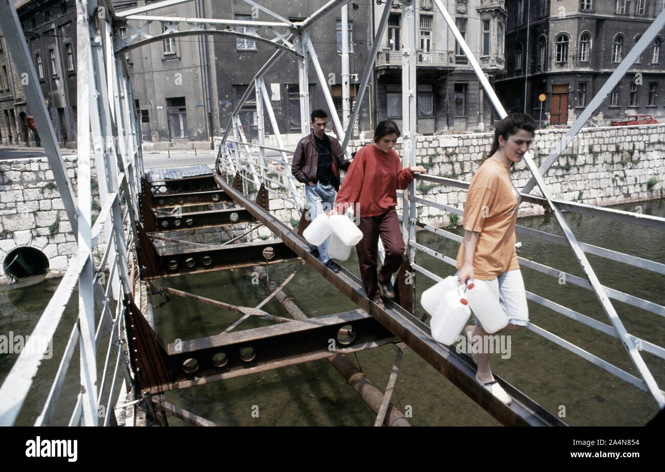 5 Giugno 1993 durante l'assedio di Sarajevo: musulmani bosniaci croce attentamente quello che è a sinistra del ponte Ćumurija, sul loro modo di raccogliere acqua potabile. Foto Stock