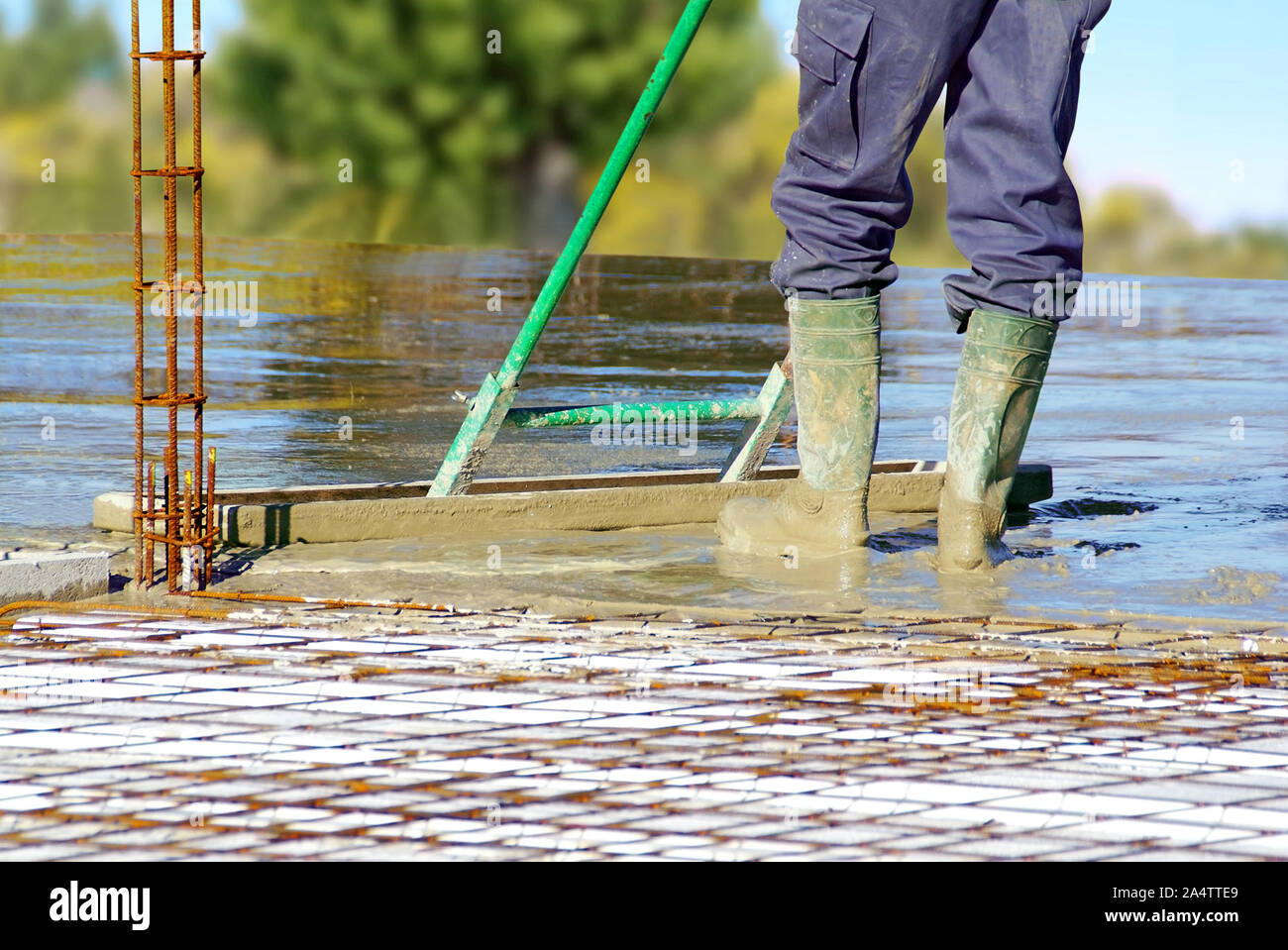 La distribuzione di calcestruzzo per la realizzazione del pavimento di una casa in costruzione. Foto Stock