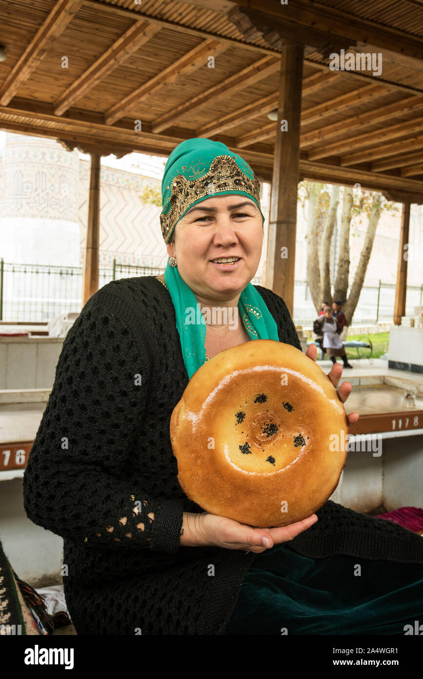 Pane uzbeko venditore al Siyob Bazaar. Samarcanda, un sito Patrimonio Mondiale dell'UNESCO. Uzbekistan Foto Stock