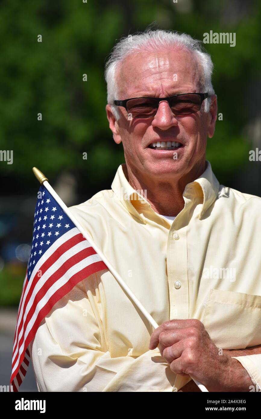 Ritirato patriottica uomo con bandiera degli Stati Uniti in estate Foto Stock