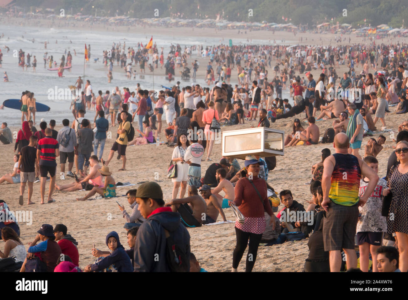 Una grande folla di persone sulla spiaggia di Kuta Beach a Bali, in Indonesia Foto Stock