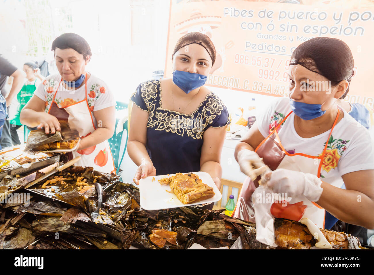 Merida, Messico - 28 Ottobre 2018: Le donne che mostra Pibes, pollo tradizionale piatto di mais avvolto in banana leafes venduto per il giorno dei morti in San Sebastian Park Foto Stock Merida, Messico - 28 Ottobre 2018: Le donne che mostra Pibes, pollo tradizionale piatto di mais avvolto in banana leafes venduto per il giorno dei morti in San Sebastian Park Foto Stock