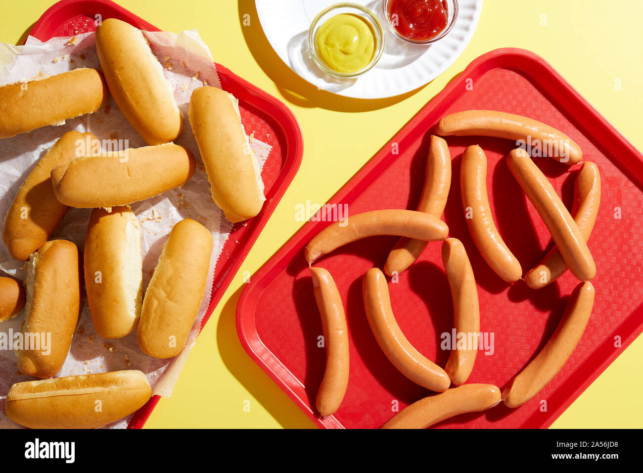 Il vassoio del pane dito rotoli e vassoio di hotdog su sfondo giallo Foto Stock