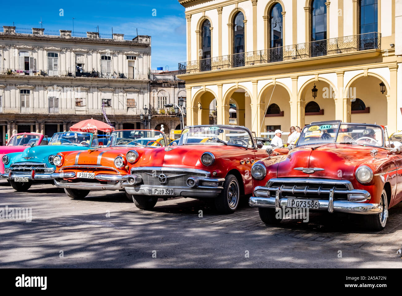 Scena di strada con Vintage Americano classico Taxi automobili in attesa per i turisti, Havana, Cuba Foto Stock