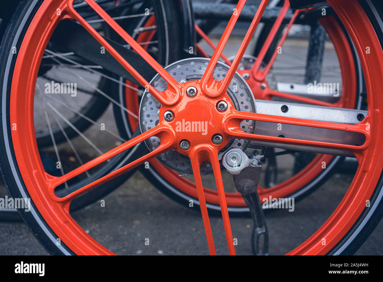 Chiudere un cerchio arancione di una bicicletta a noleggio Foto Stock