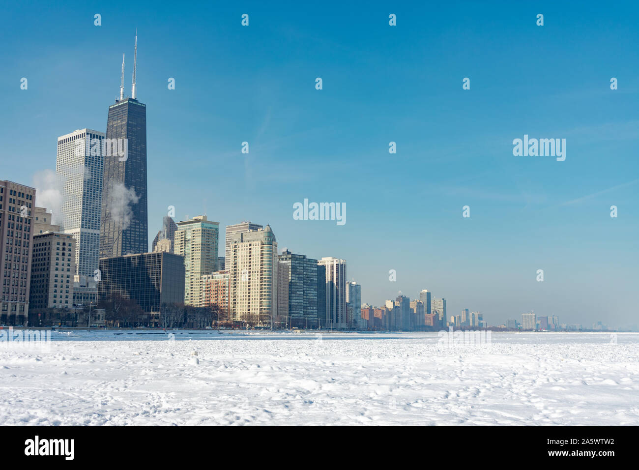 Chicago Skyline visto da Ohio Street Beach con il lago Michigan coperto di neve e ghiaccio dopo un Polar Vortex Foto Stock