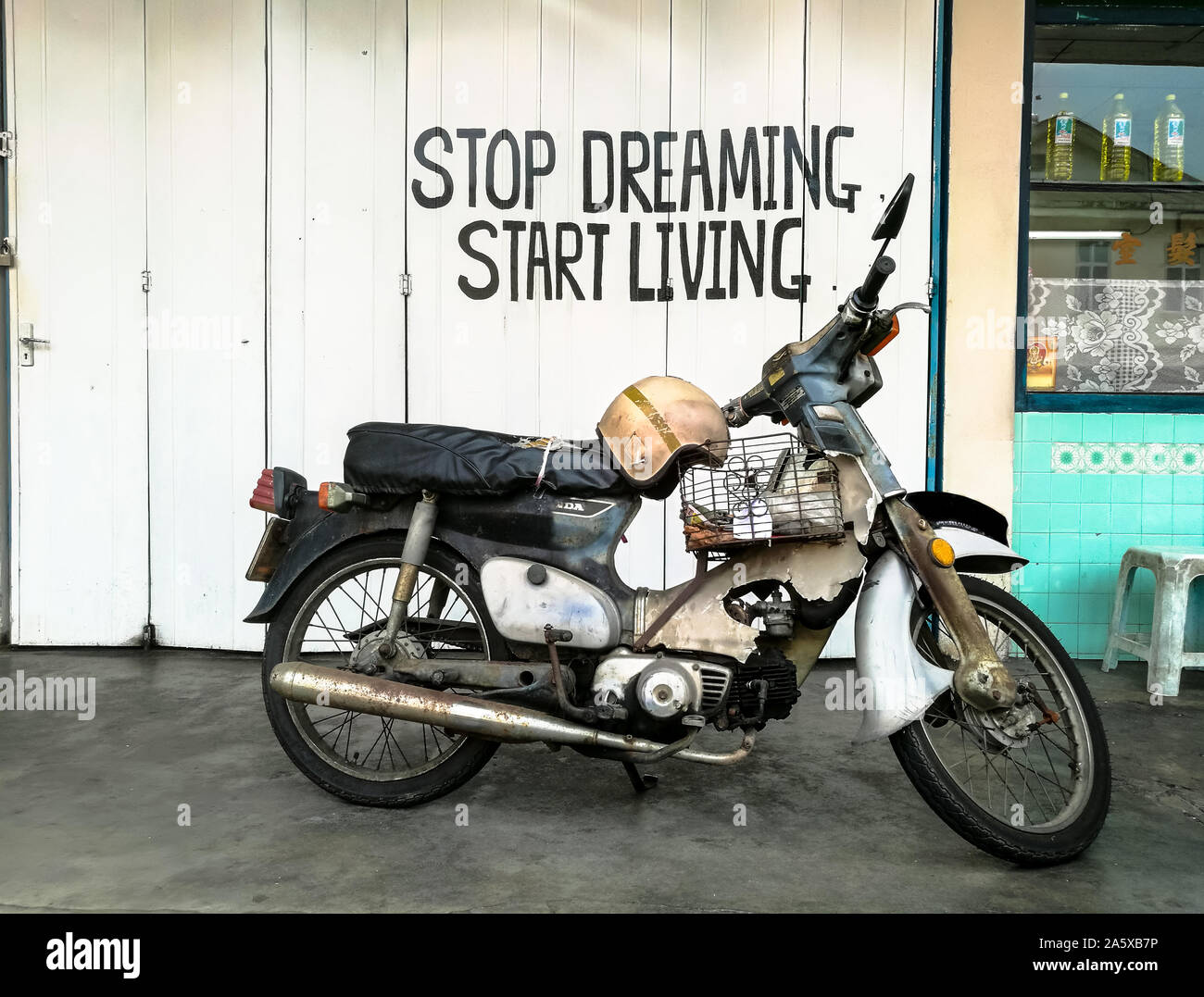 Smettere di sognare inizia a vivere preventivo slogan sullo sfondo con la  vecchia moto in primo piano Foto stock - Alamy