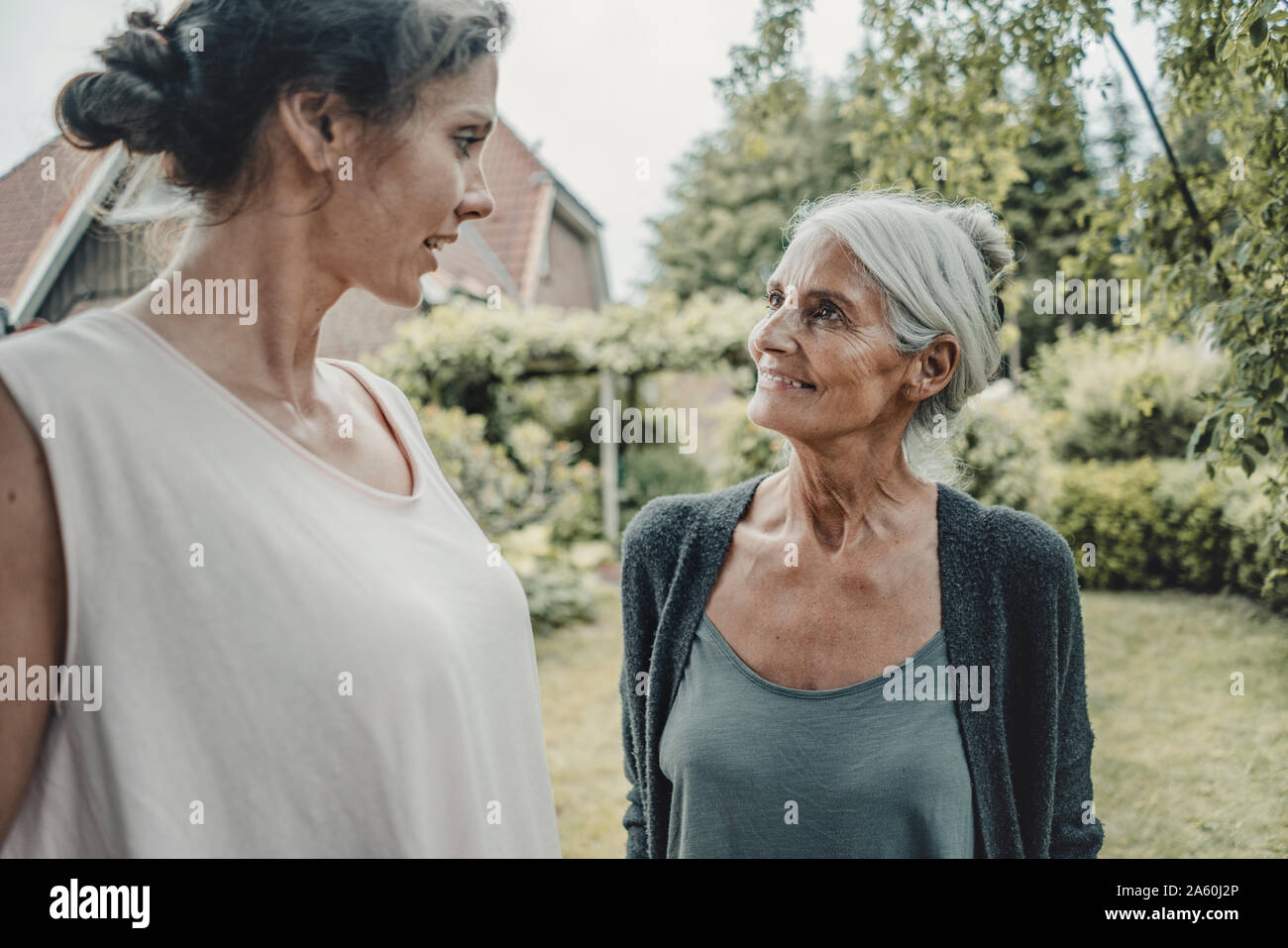 Madre e figlia parlano in giardino Foto Stock