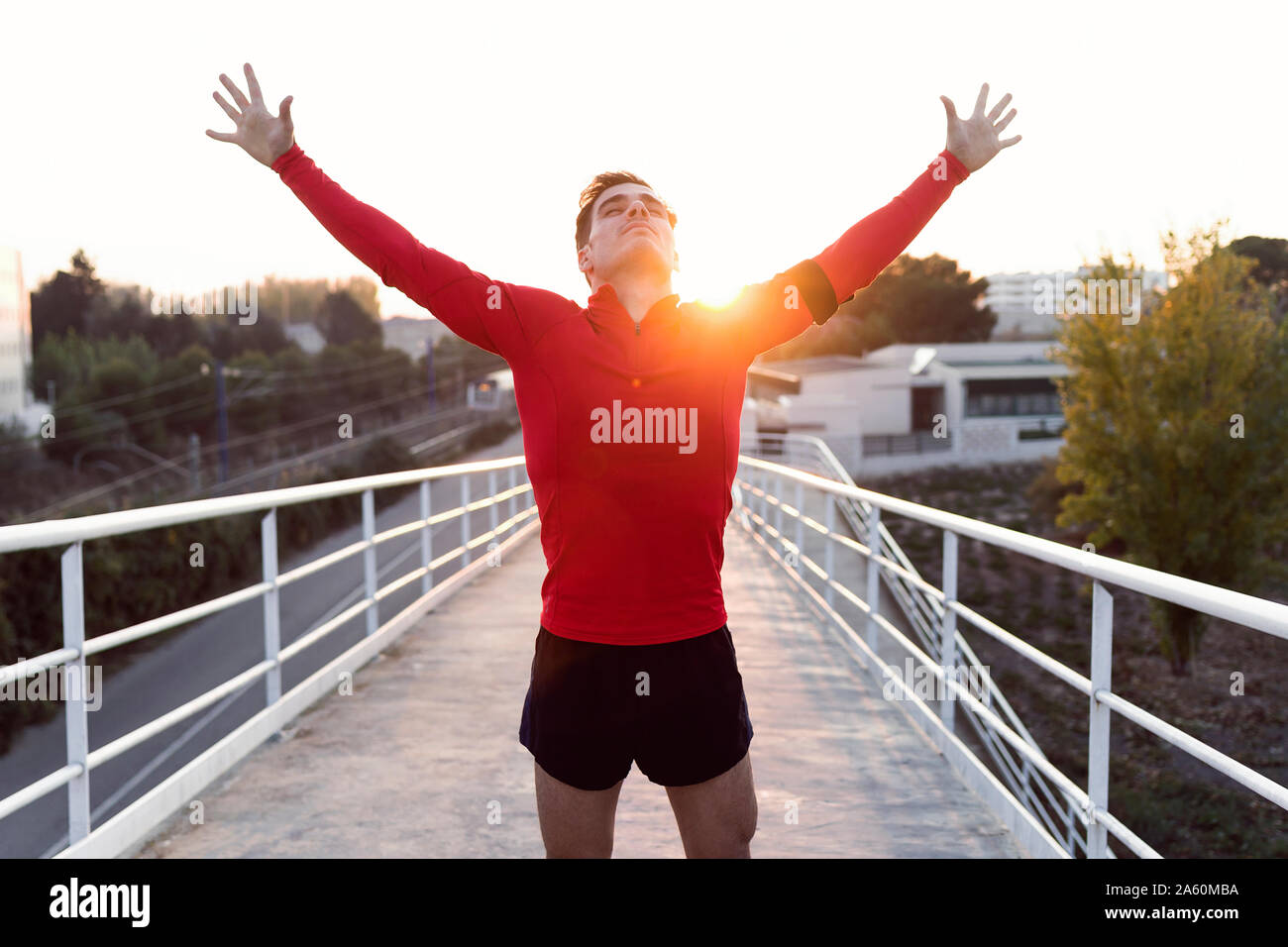Pareggiatore con lo smartphone nella tasca del braccio con le braccia sollevate Foto Stock