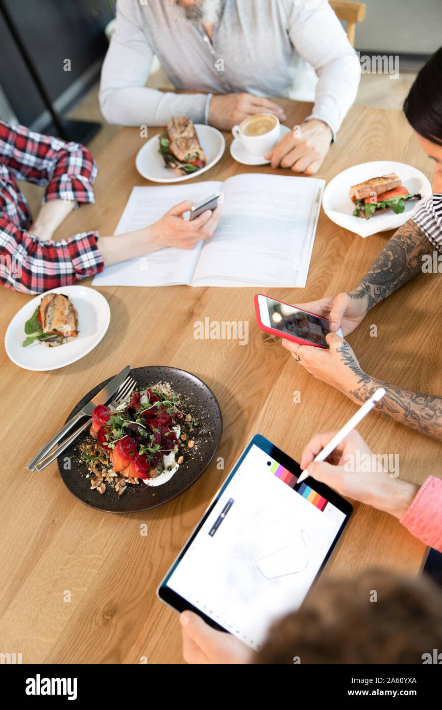 Business Casual persone avendo pranzo di lavoro in un cafe Foto Stock