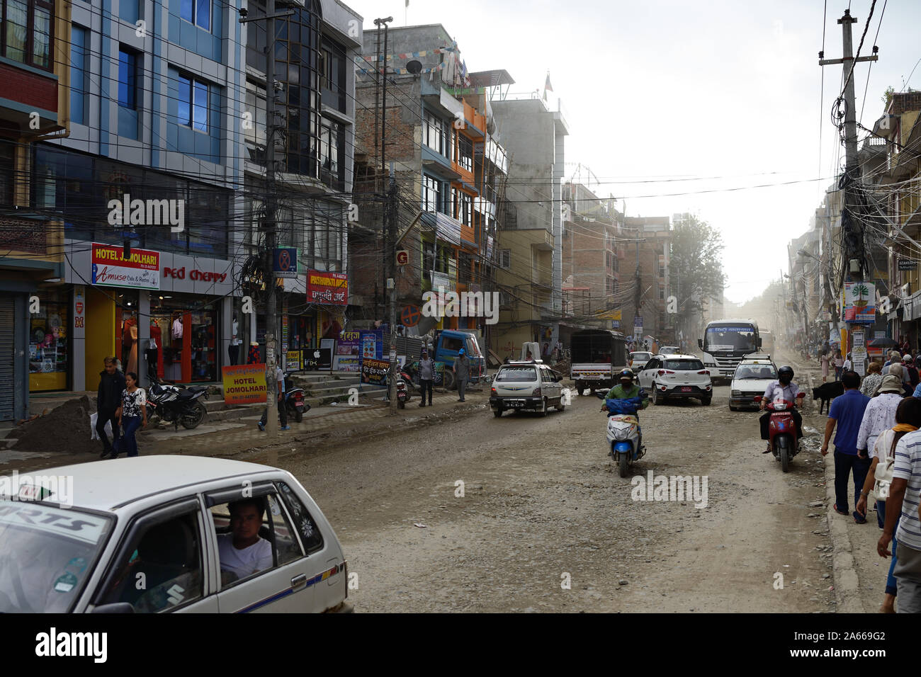 Boudha Road è un occupato, mal mantenuta road nel centro di Kathmandu, Nepal. Spesso è impolverato in condizioni di tempo asciutto e inondate in condizioni di bagnato. Foto Stock