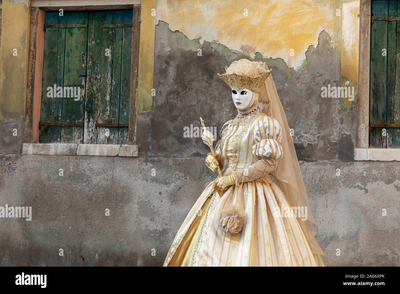 Una donna pone di fronte a una facciata di affievolimento durante il Carnevale di Venezia , Venezia, Veneto, Italia Foto Stock