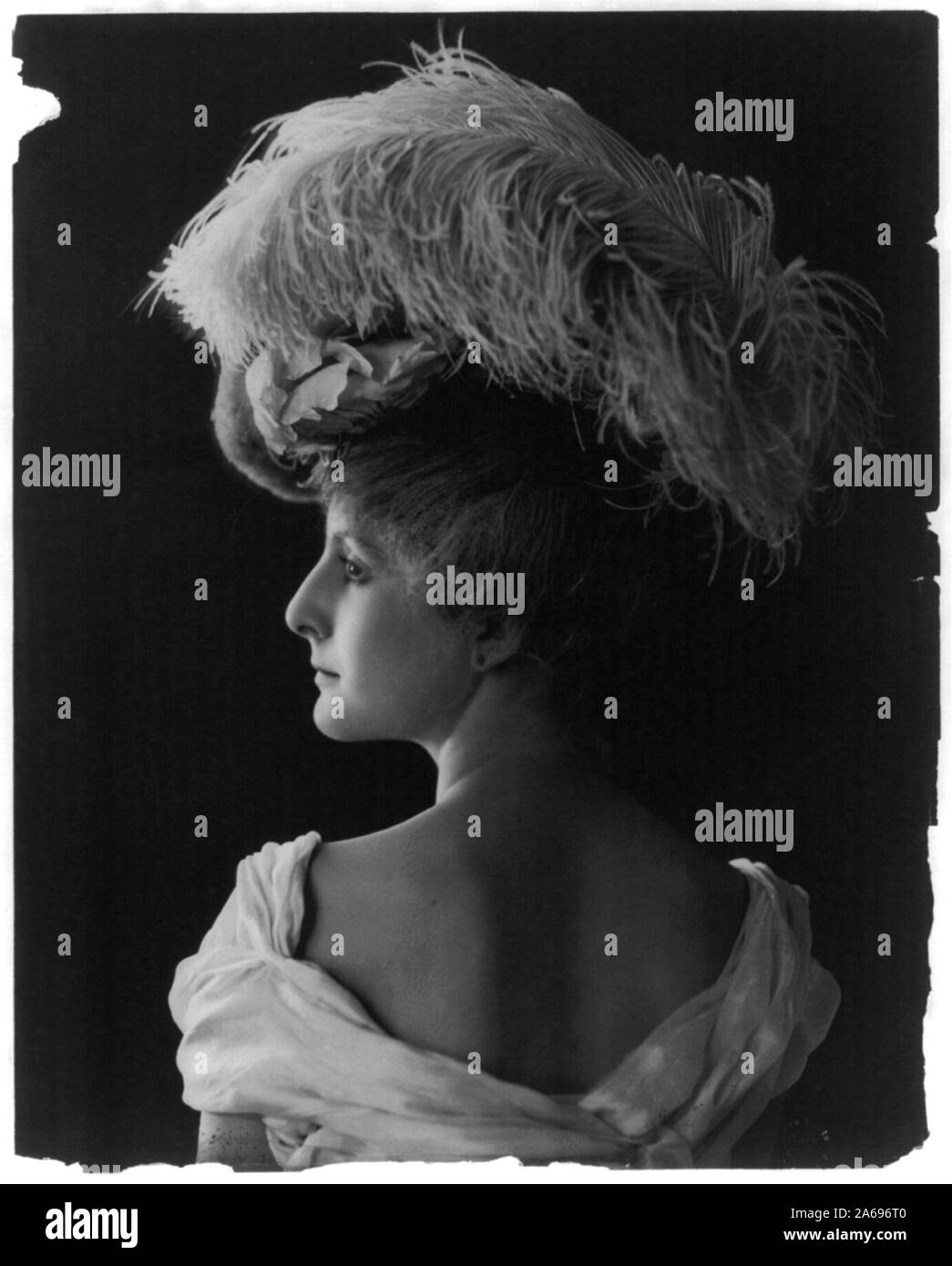 Giovane donna di modellazione: vista posteriore, testa e spalle, indossare un cappello piumato Foto Stock