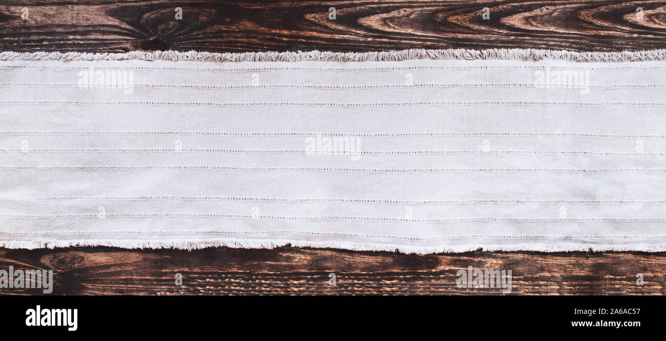 Tessuto grigio runner su un vecchio rustico in legno sfondo tabella con copia spazio. Vista dall'alto. Foto Stock