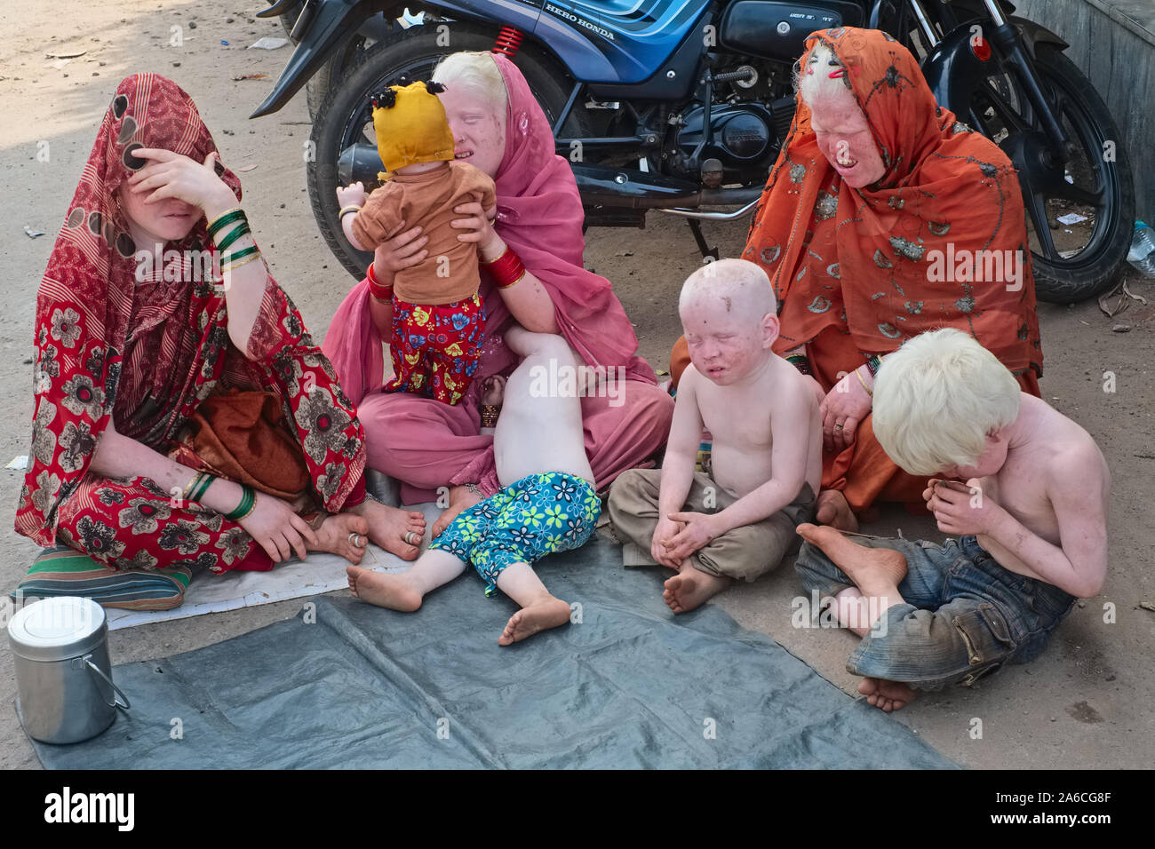 Indian albino le donne e i loro bambini albini nascosto dalla luce del sole mentre richiedono donazioni in Udipi (Udupi), Karnataka, India Foto Stock