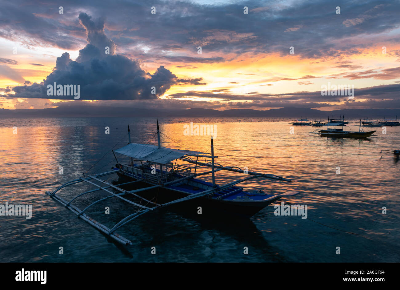 Barche a Panagsama Beach durante il tramonto, Moalboal, Cebu, Filippine. Foto Stock